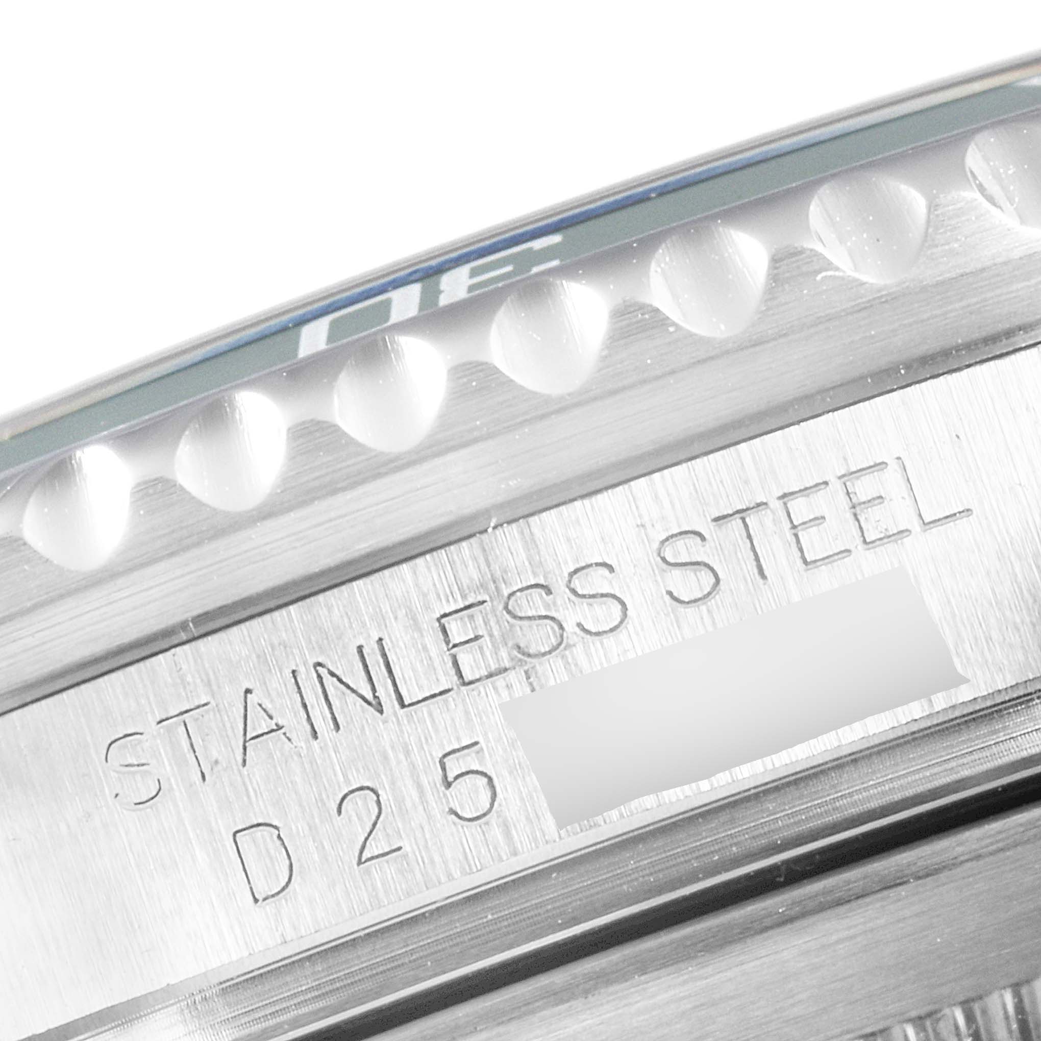 The image shows a close-up of the side view of the Rolex Submariner 16610LV Men
s Stainless Steel Black Dial 16610LV Men
s Stainless Steel Black Dial watch, focusing on the stainless steel engraving and part of the bezel.