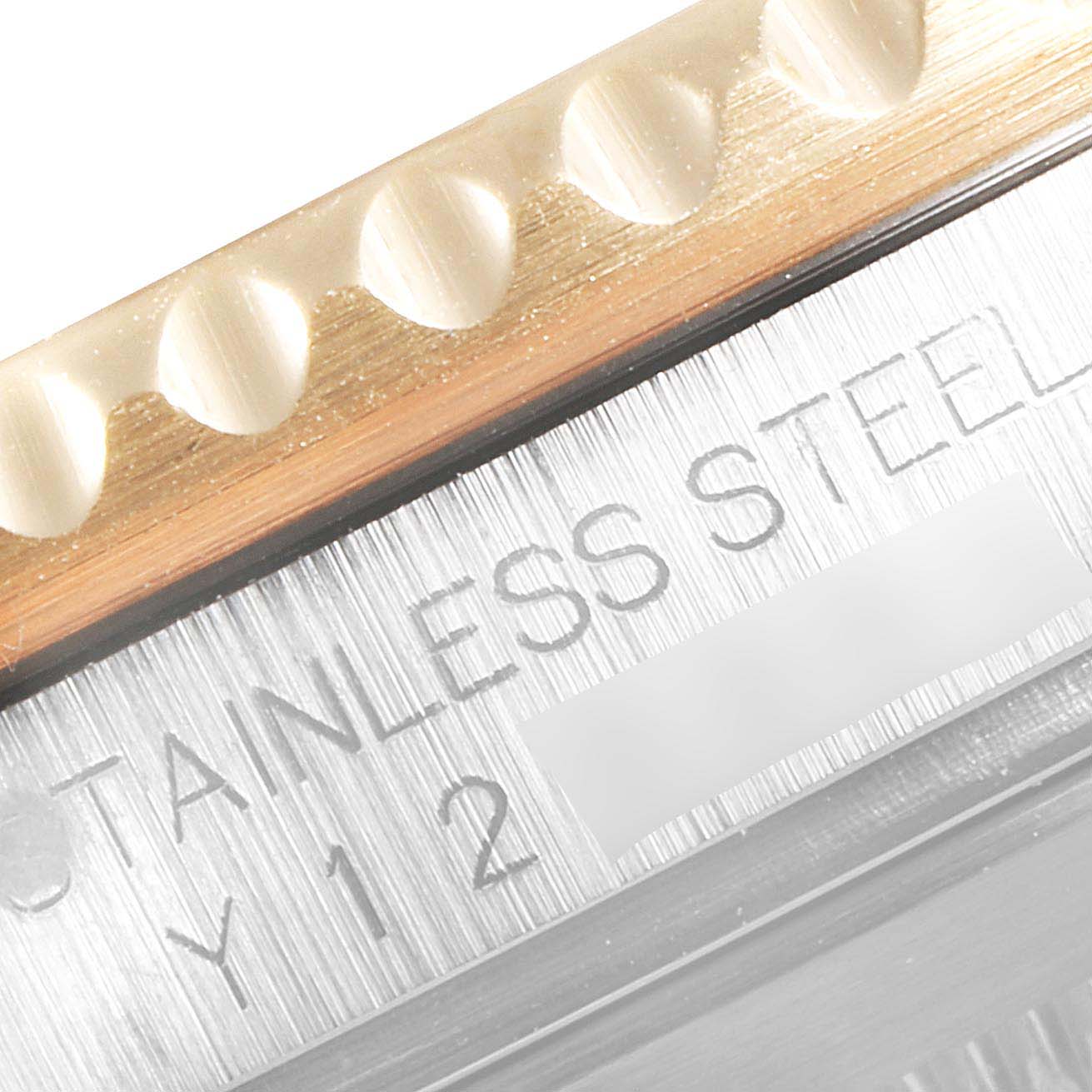 This close-up shows the bezel and part of the case with "STAINLESS STEEL" engraving on a Rolex Submariner 16613 Men
s Steel and Gold (two tone) Black Dial 16613 Men
s Steel and Gold (two tone) Black Dial watch.