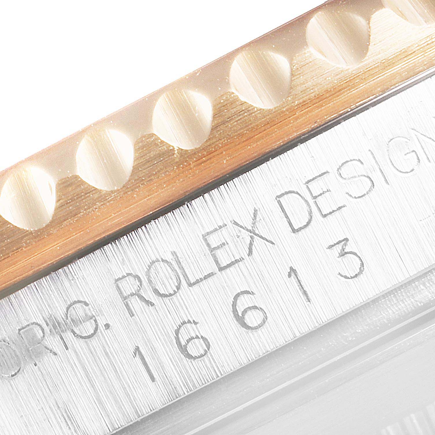 The image shows a close-up of the bezel and case engraving of the Rolex Submariner 16613 Men
s Steel and Gold (two tone) Black Dial 16613 Men
s Steel and Gold (two tone) Black Dial 16613.