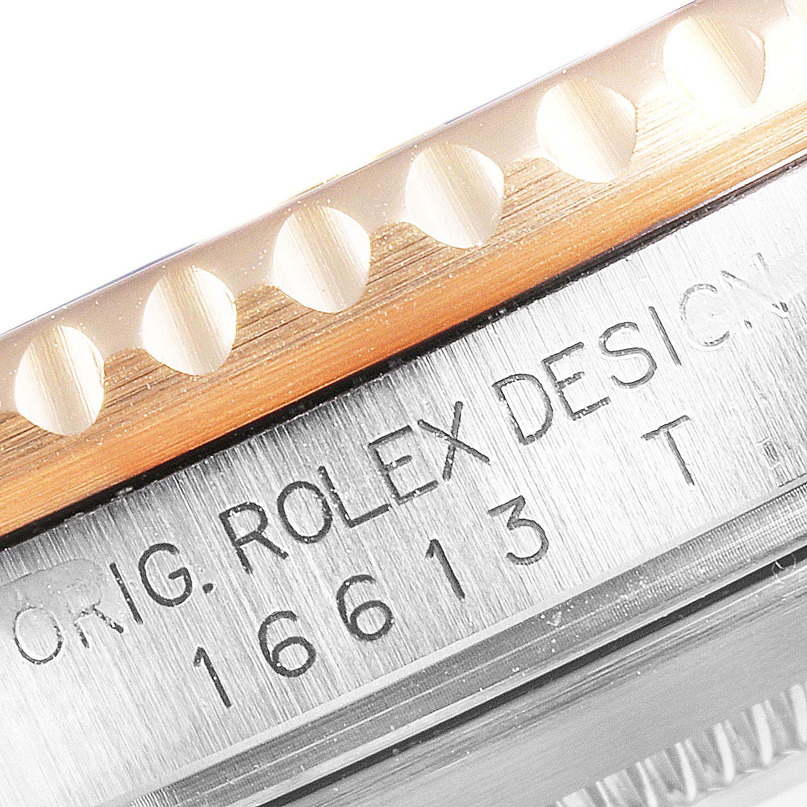 This close-up of the Rolex Submariner 16613 Men
s Steel and Gold (two tone) Blue Dial 16613 Men
s Steel and Gold (two tone) Blue Dial shows part of the bezel and engraved model number.