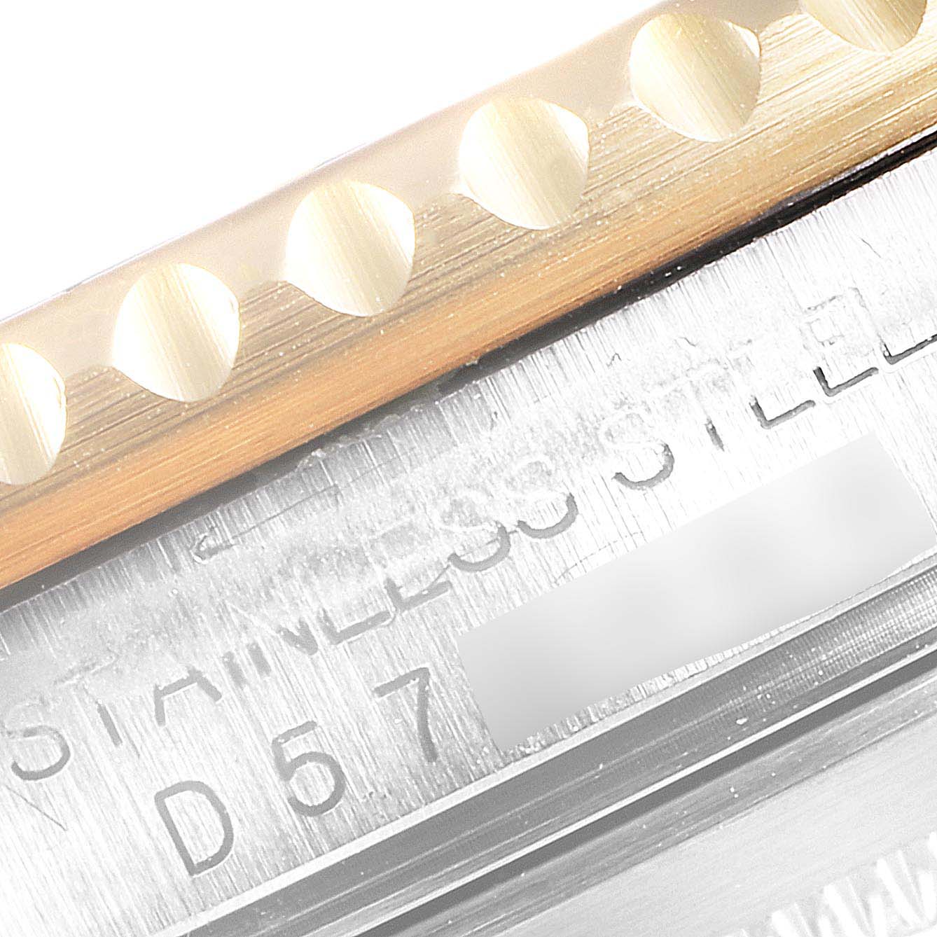 The image shows a close-up of the metal bezel and part of the case edge on a Rolex Submariner 16613 Men
s Steel and Gold (two tone) Blue Dial 16613 Men
s Steel and Gold (two tone) Blue Dial watch.