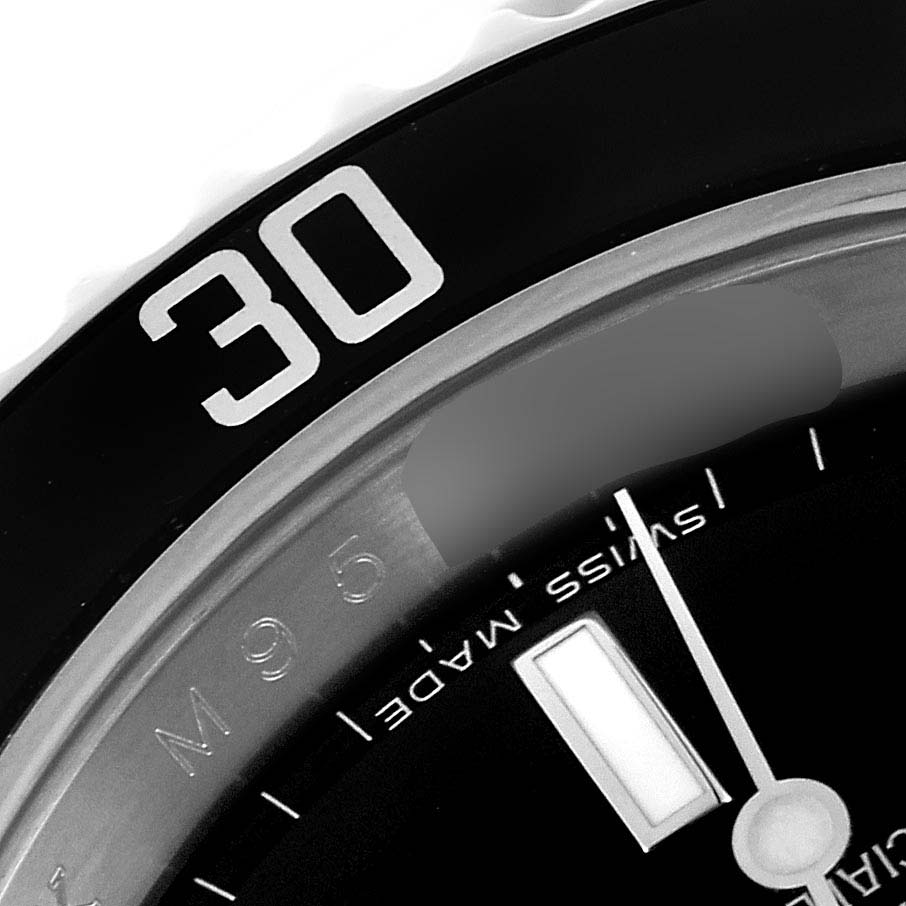 This image shows a close-up of the bezel and part of the dial of a Rolex Submariner 16610 Men
s Stainless Steel Black Dial 16610 Men
s Stainless Steel Black Dial watch, focusing on the 30-minute marker.