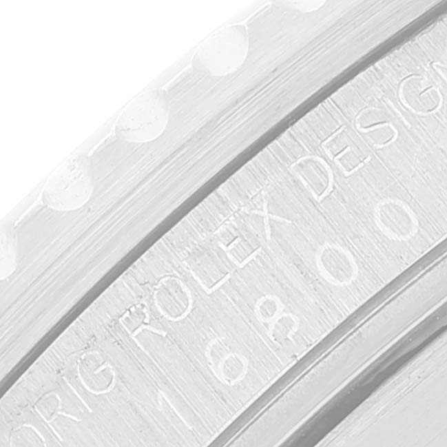 This close-up image shows the engraved text on the side of a Rolex Submariner 16800 Men
s Stainless Steel Black Dial 16800 Men
s Stainless Steel Black Dial model
s case.