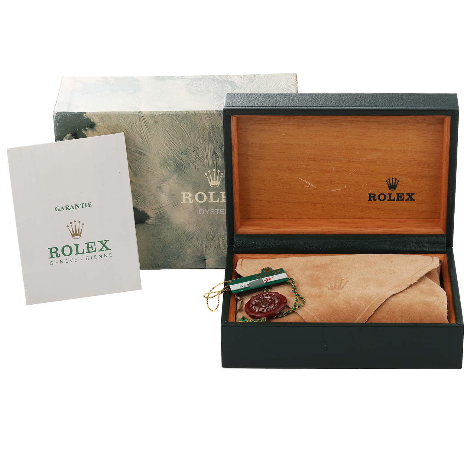 The image shows a Rolex Submariner 16800 Men
s Stainless Steel Black Dial 16800 Men
s Stainless Steel Black Dial
s box, manual, warranty card, and tags, with the box open to reveal a suede pouch.
