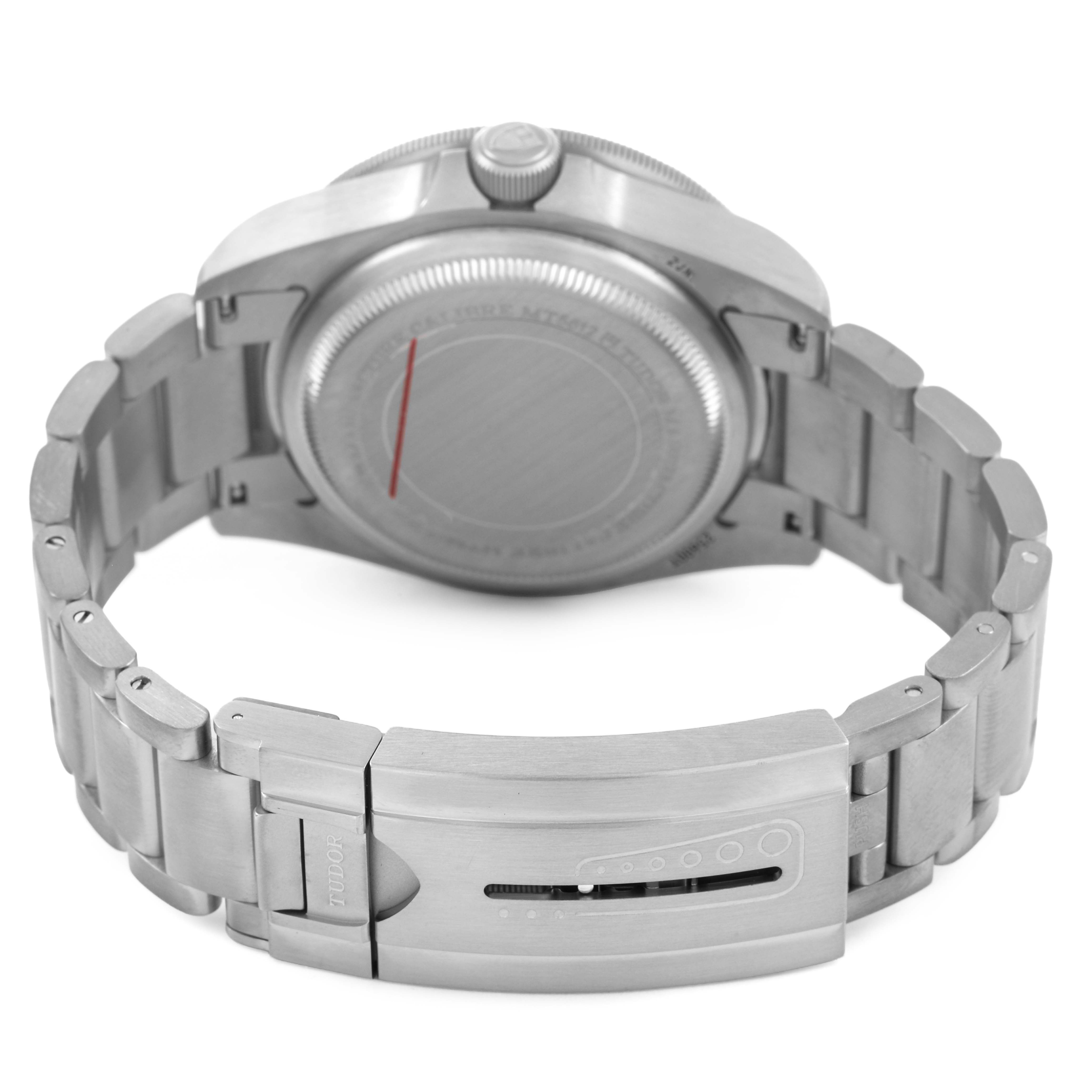 The image shows the back and clasp of the Tudor Pelagos 25600TN Men's Titanium Black Dial watch with its metal bracelet.