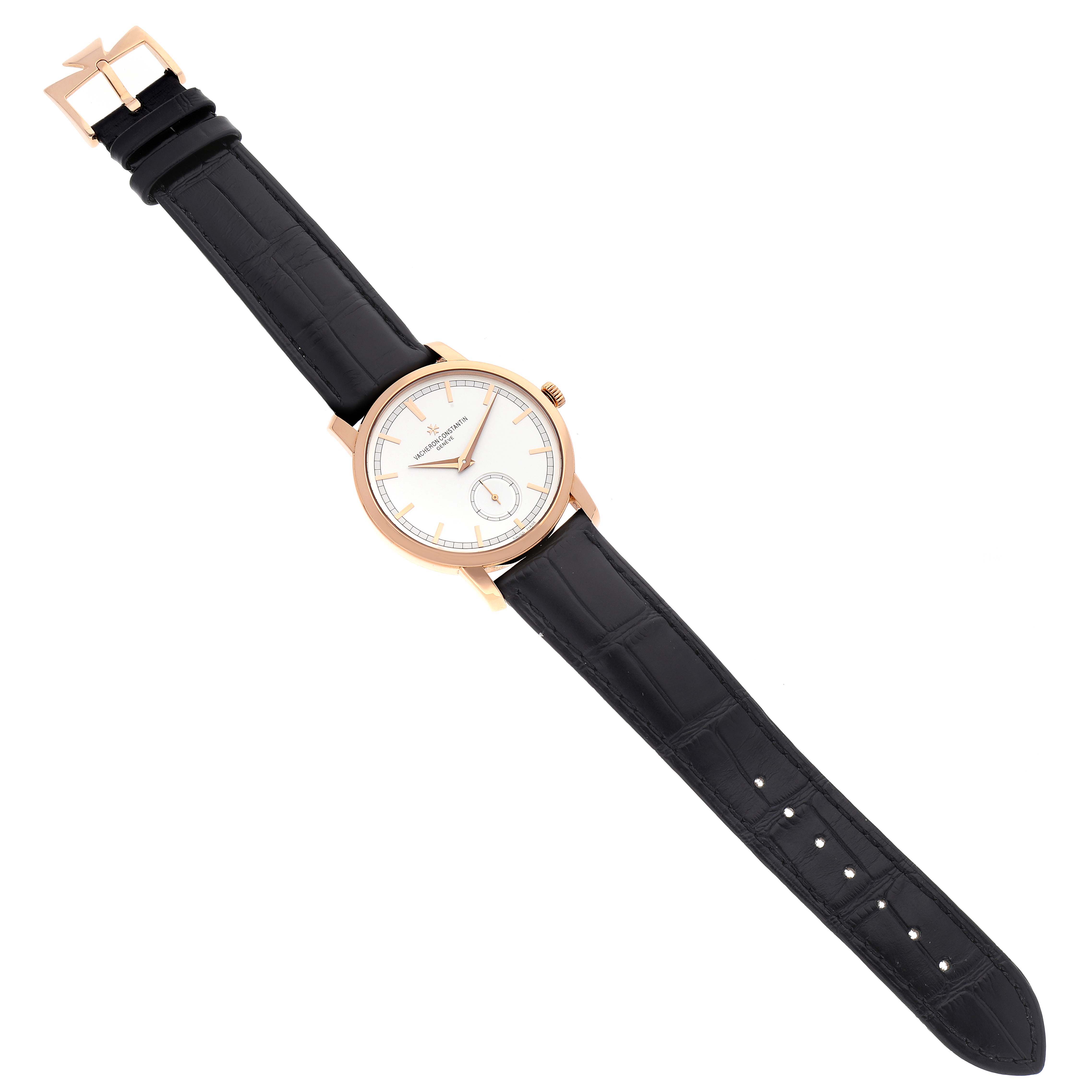 The Traditionnelle model by Vacheron Constantin is shown from a top-down angle, highlighting the dial, crown, and black leather strap with a unique clasp.