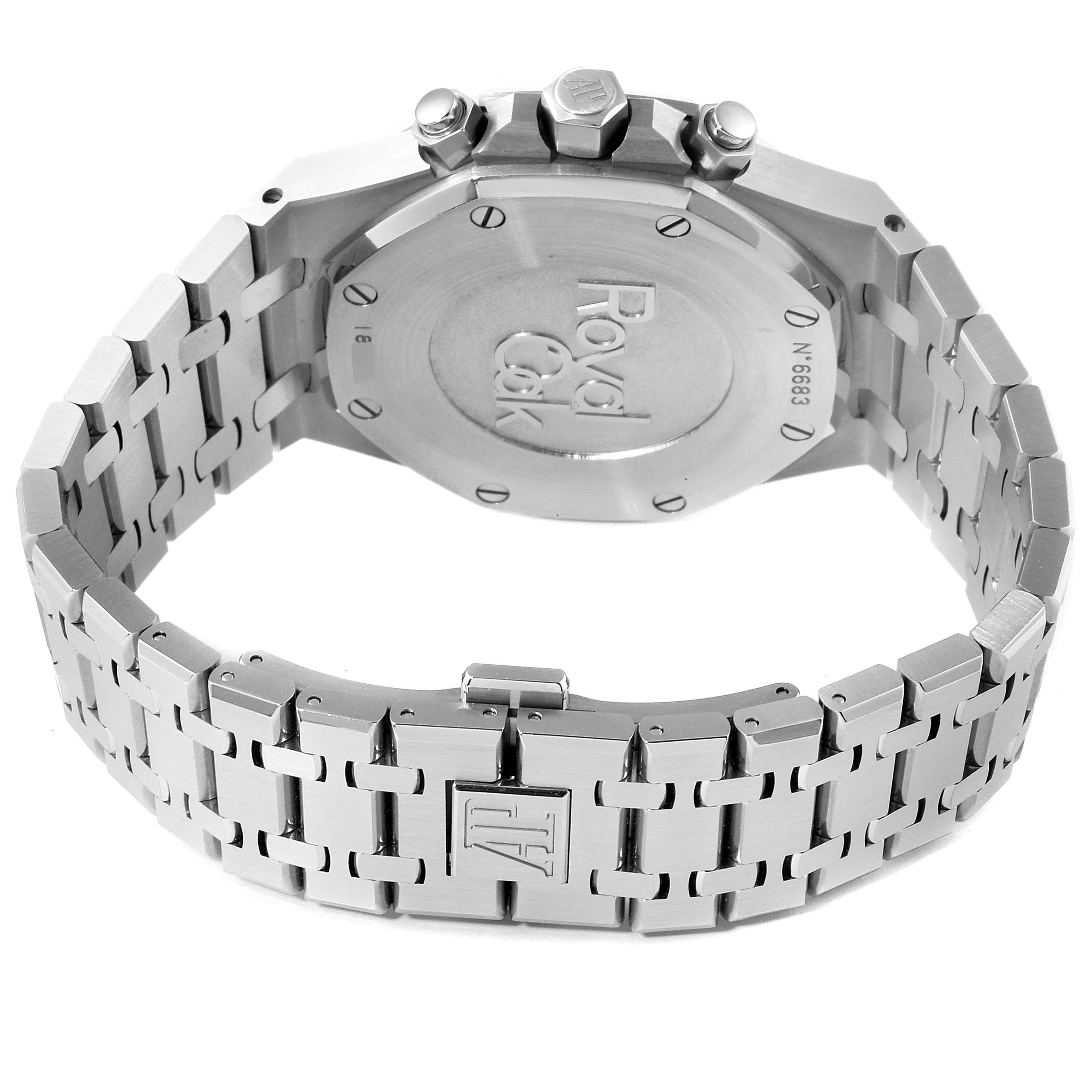 The image displays the back case and stainless steel bracelet of a Royal Oak watch by Audemars Piguet, showcasing the brand engravings and clasp.