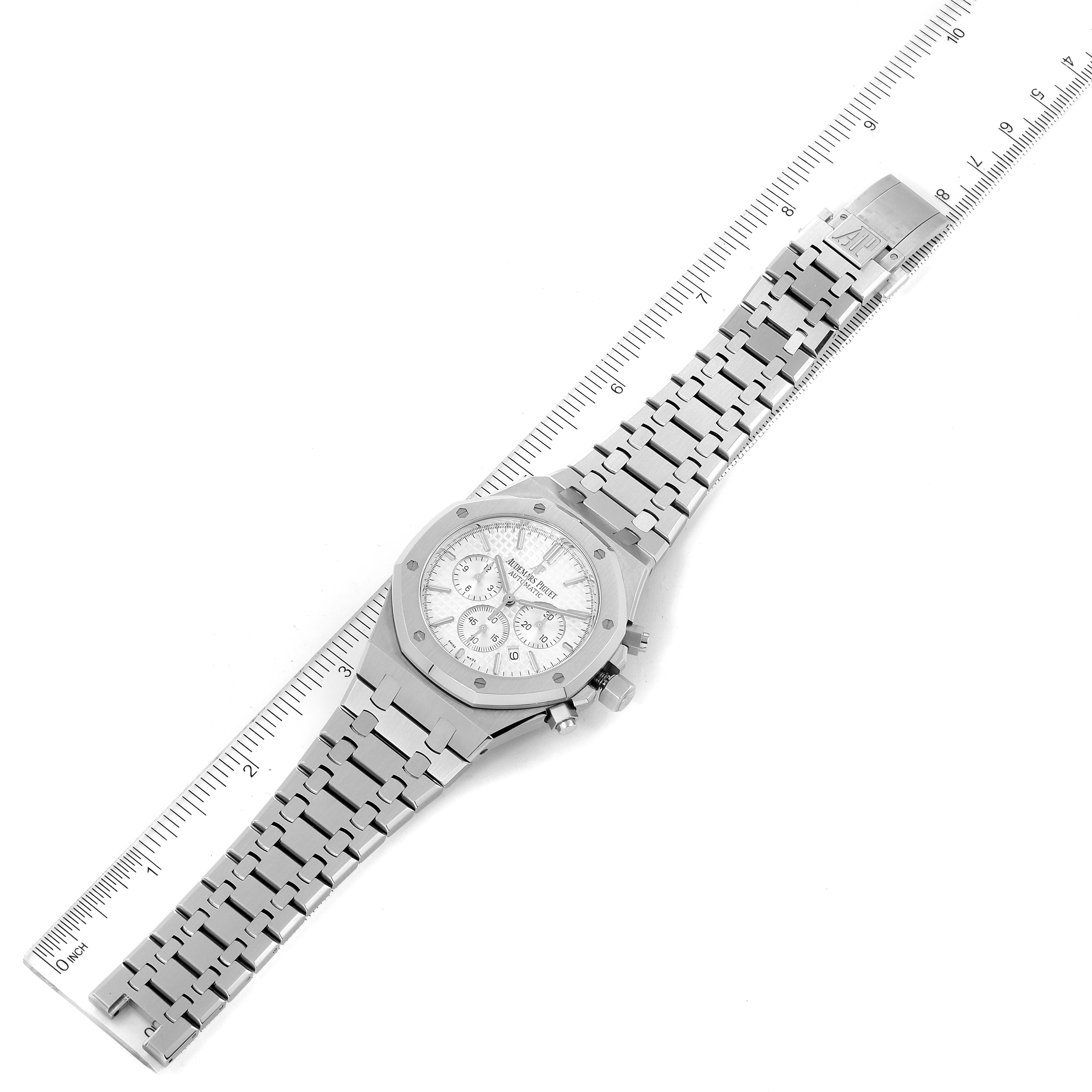 This image shows a top-down view of the Audemars Piguet Royal Oak 26320ST Men's Stainless Steel Silver Dial 26320ST Men's Stainless Steel Silver Dial watch, displaying its face, bracelet, and clasp against a ruler.
