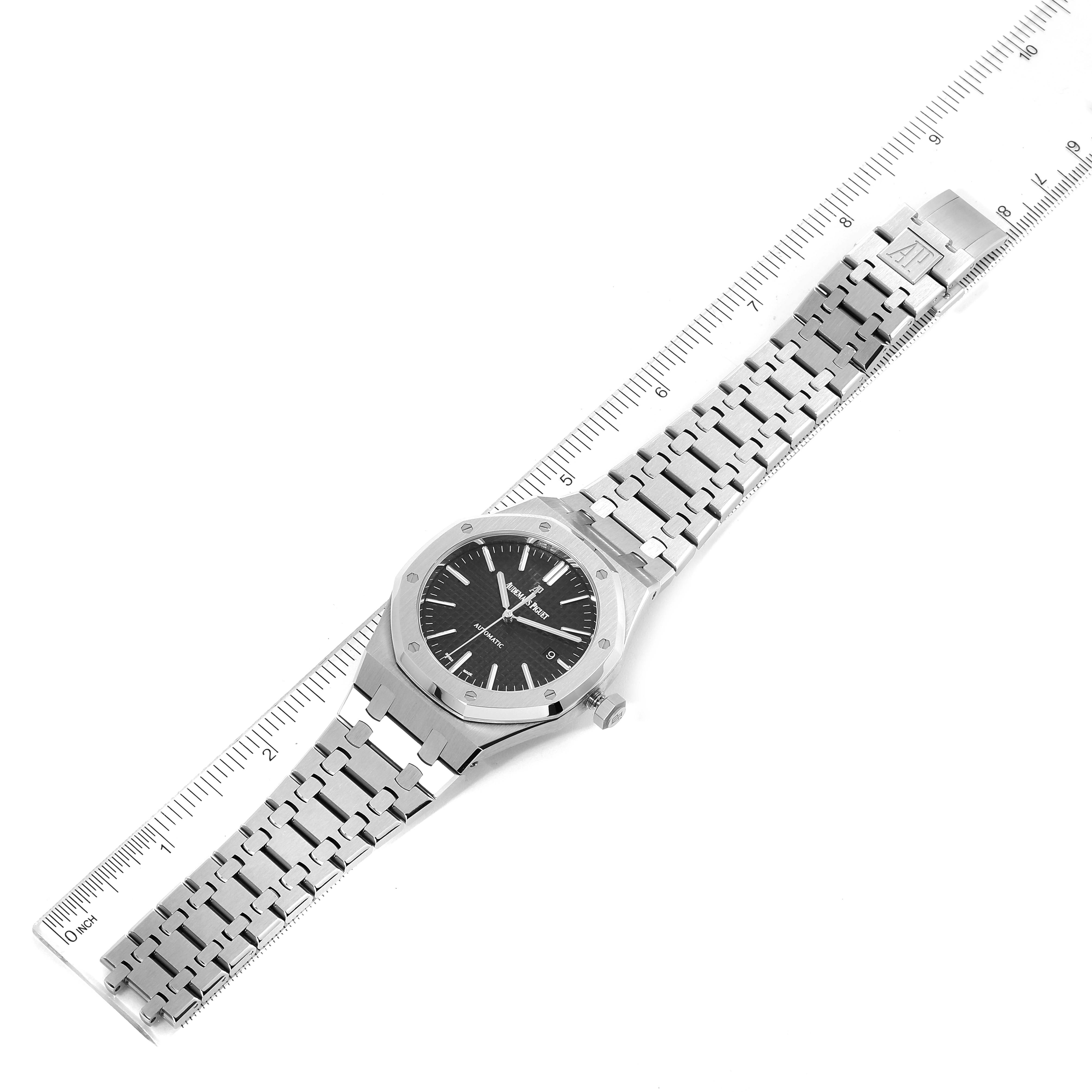 This image shows a top-down view of the Audemars Piguet Royal Oak 15400ST.OO.1220ST.01 Men's Stainless Steel Black Dial 15400ST.OO.1220ST.01 Men's Stainless Steel Black Dial watch, including its face, bracelet, and a ruler for scale.