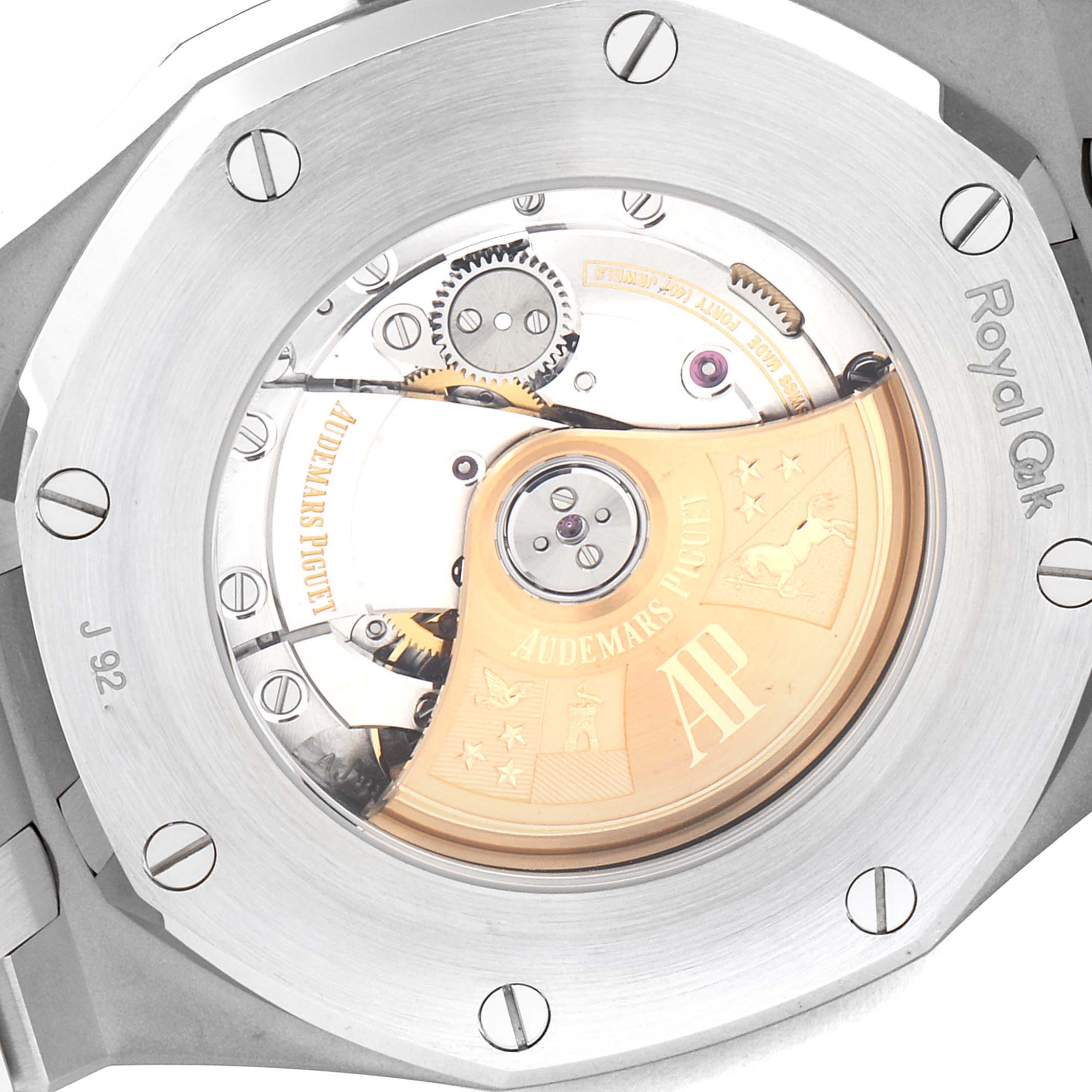 The image shows the back of a Royal Oak model by Audemars Piguet, highlighting its exposed movement and rotor.