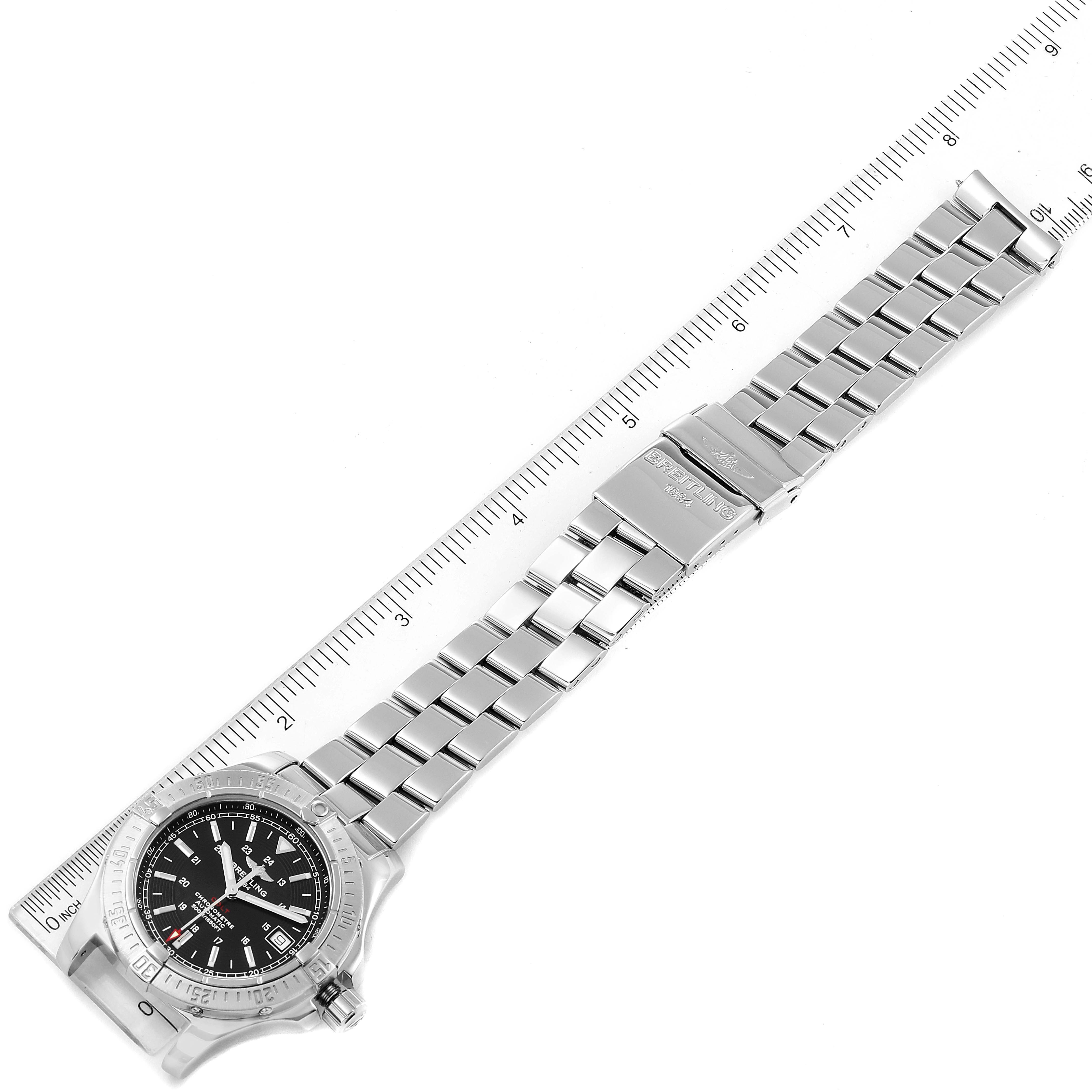 This image shows the entire Breitling Colt A17380 Men's Stainless Steel Black Dial A17380 Men's Stainless Steel Black Dial model watch, including its face and full metal band, laid next to a ruler.