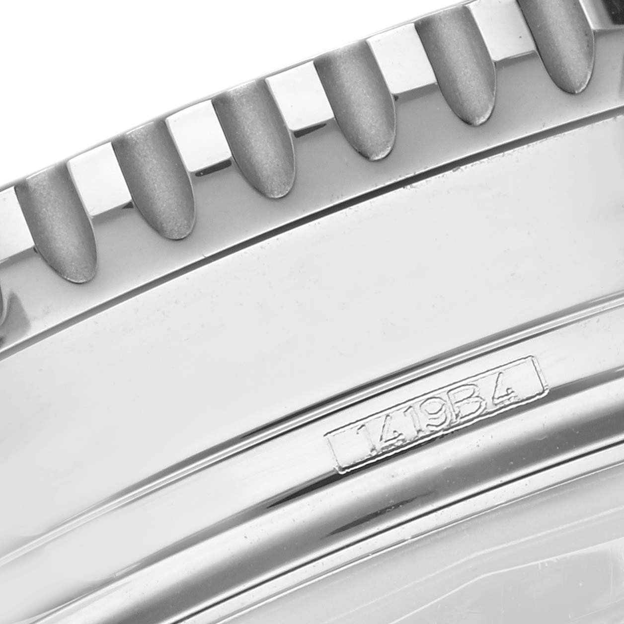 This close-up image of the Breitling Navitimer A13324121C1A1 Men's Stainless Steel Blue Dial A13324121C1A1 Men's Stainless Steel Blue Dial watch shows the bezel with serrated edges and a part of the case with model engraving.