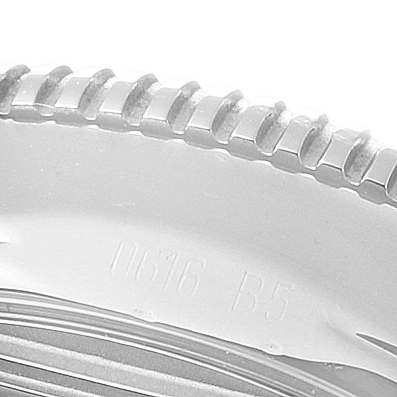 The image shows a close-up of the bezel edge of a Breitling Superocean A17321 Men's Stainless Steel Black Dial A17321 Men's Stainless Steel Black Dial model watch.