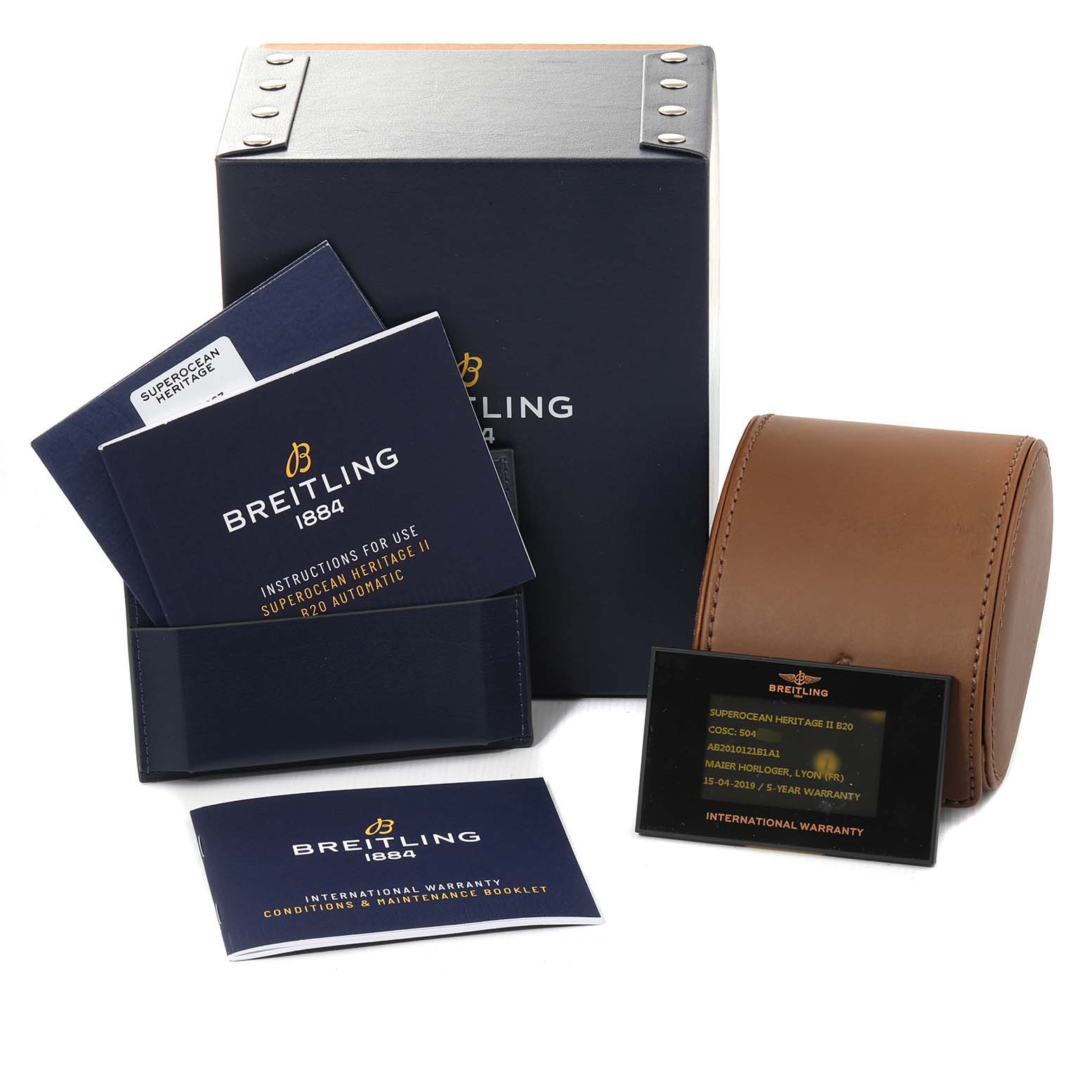 The image shows an upright view of Superocean by Breitling's packaging, booklet, warranty card, and watch case.