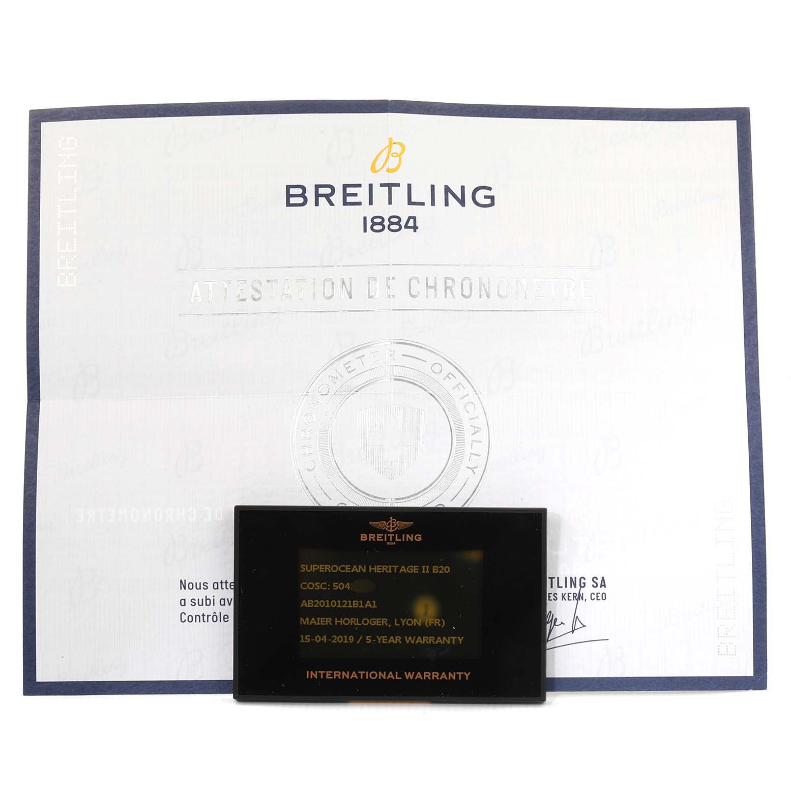 This image shows the warranty card and chronometer certificate for the Breitling Superocean AB2010161C1A1 Men's Stainless Steel Black Dial AB2010161C1A1 Men's Stainless Steel Black Dial model, taken from a front angle.