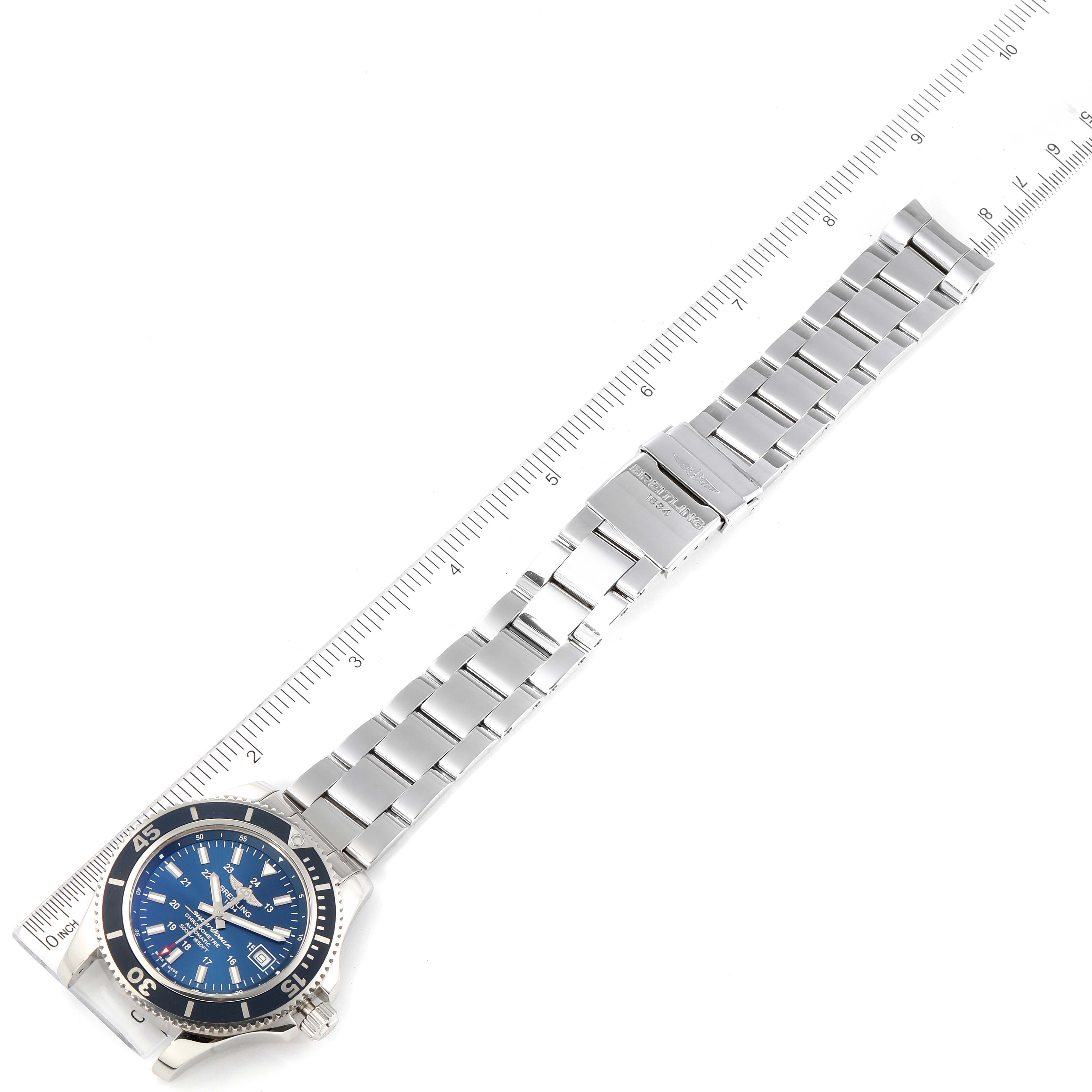 The Breitling Superocean A17365 Men's Stainless Steel Blue Dial A17365 Men's Stainless Steel Blue Dial watch is shown laid flat with its metal bracelet and clasp fully visible alongside a ruler.