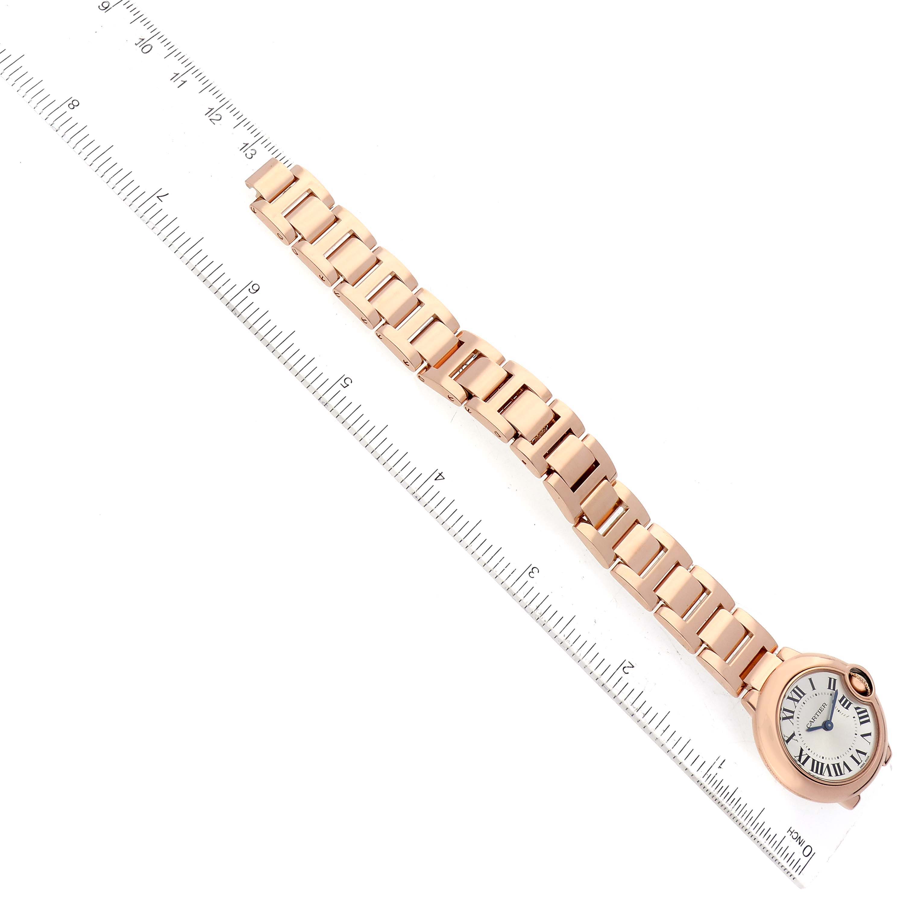 The image displays a Cartier Ballon Bleu W69002Z2 Women's Rose Gold Silver Dial W69002Z2 Women's Rose Gold Silver Dial watch laid flat alongside a ruler, showing the face and full bracelet.