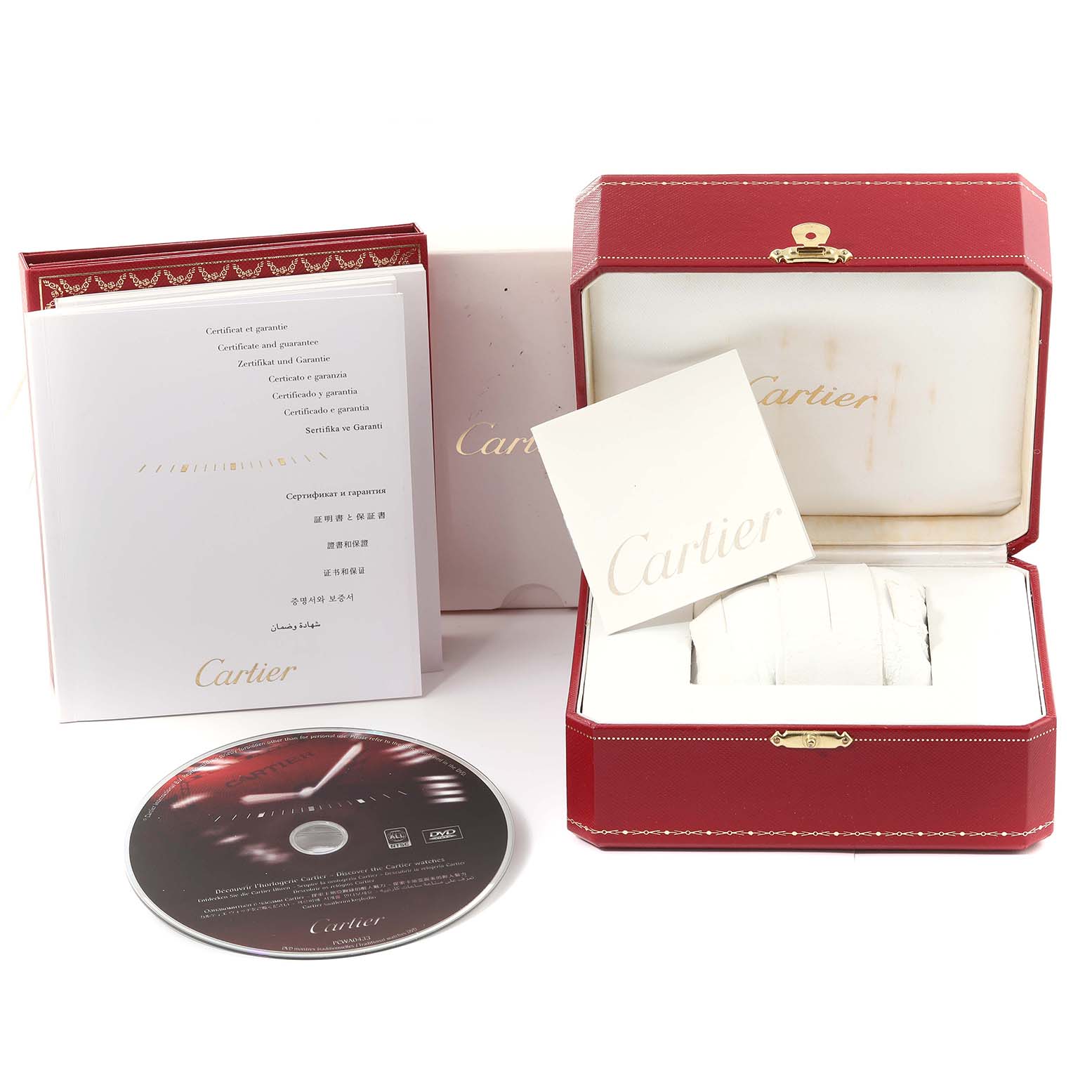 This image shows the Cartier Ballon Bleu W69001Z2 Women's Yellow Gold Silver Dial W69001Z2 Women's Yellow Gold Silver Dial watch accessories, including a red box, warranty booklet, and a DVD from a front angle.