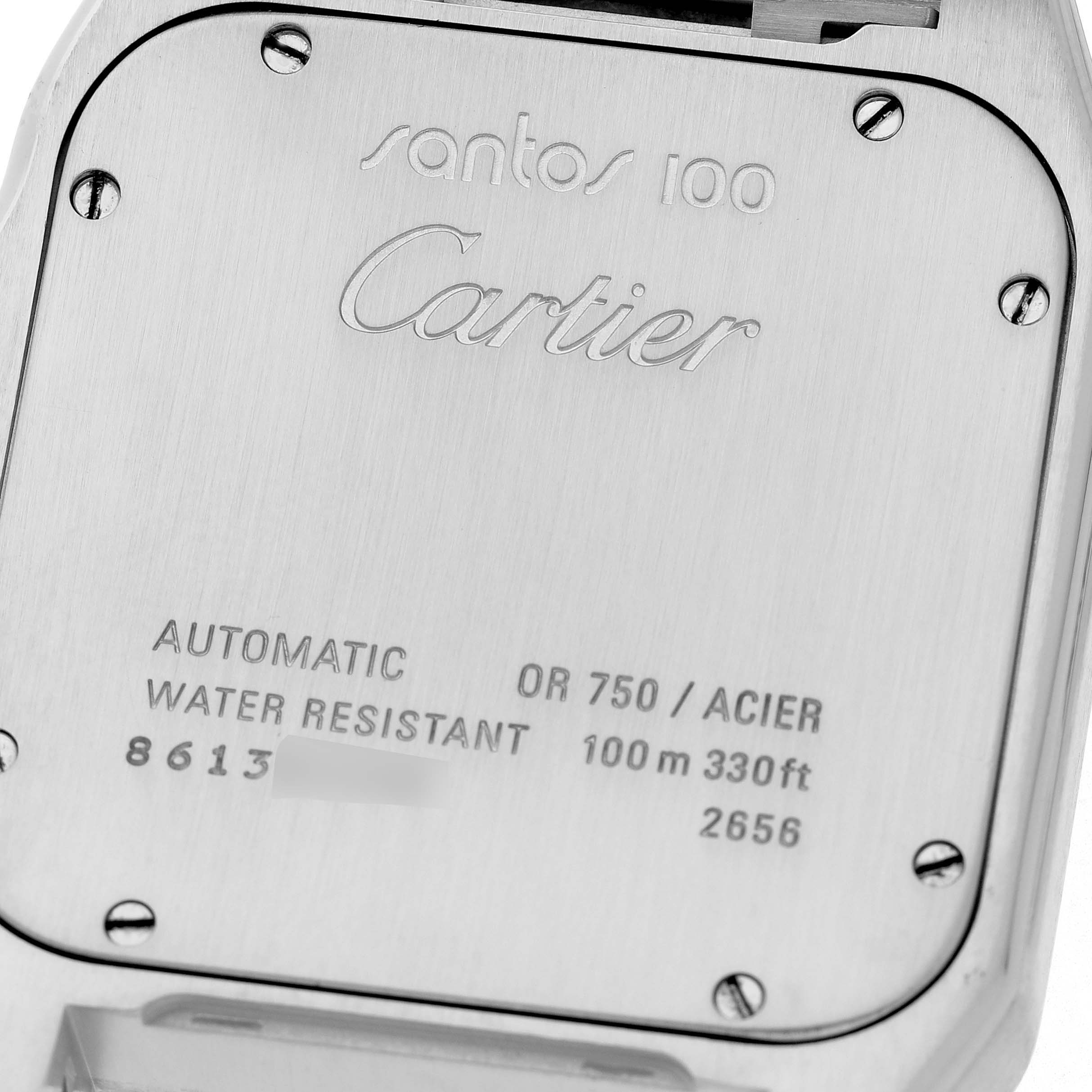 The image shows the case back of a Cartier Santos W200728G Men's Stainless Steel Silver Dial 100 watch, featuring engraved details and screws.