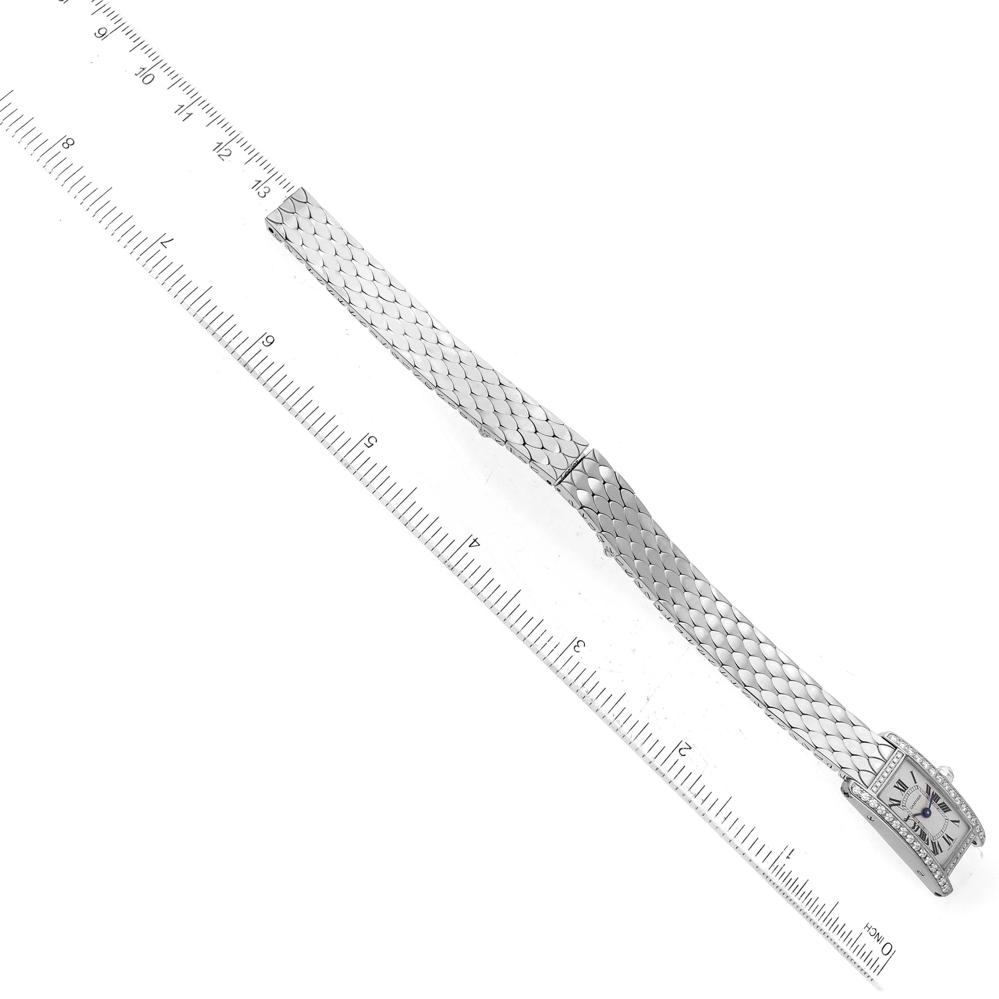The Cartier Tank Americaine WB710013 Women's White Gold Silver Dial WB710013 Women's White Gold Silver Dial watch is shown lying flat with the entire bracelet and face visible next to a ruler for scale.