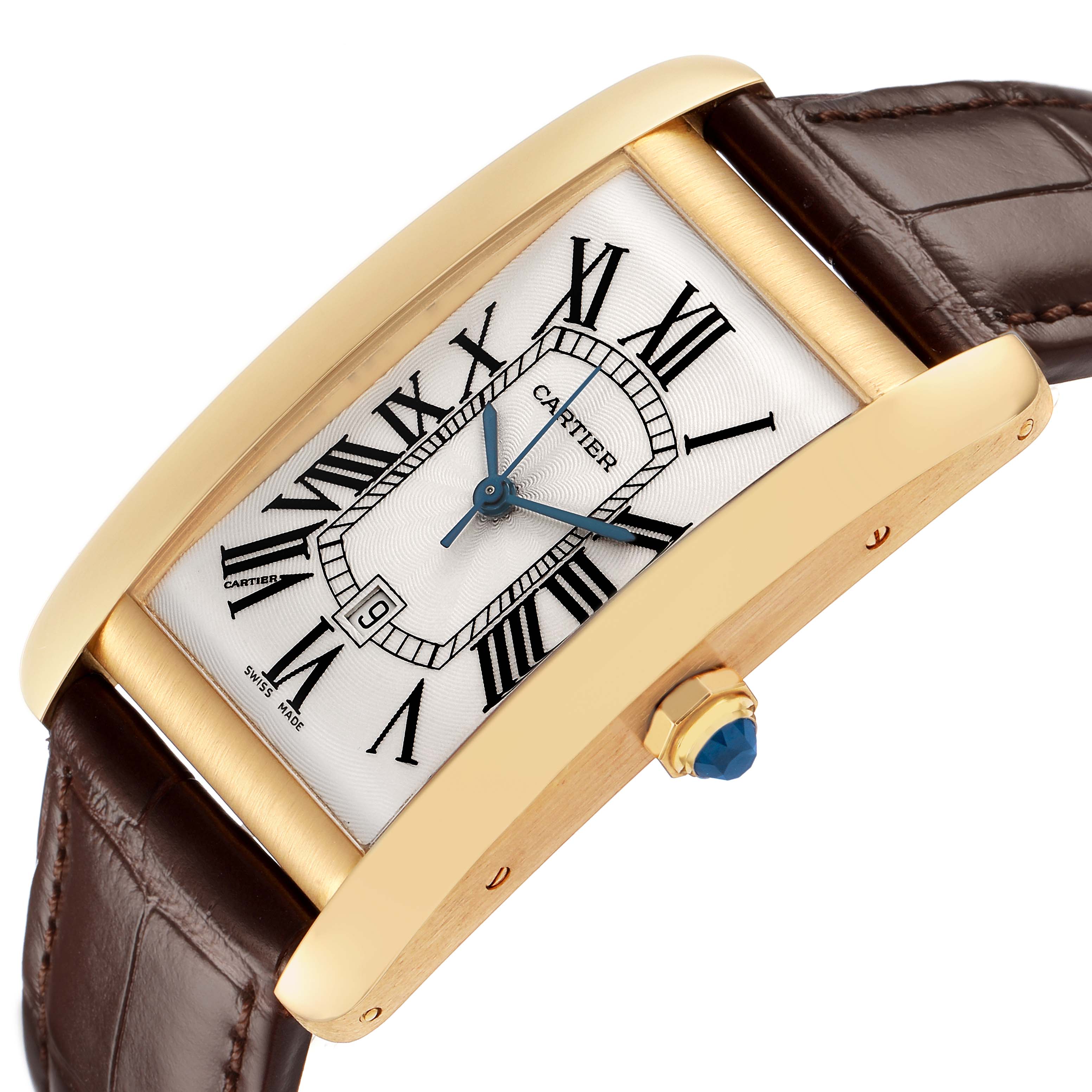 The image shows a Cartier Tank Americaine W2603156 Men's Yellow Gold Silver Dial watch angled to highlight the gold case, crown with a blue cabochon, and brown leather strap.