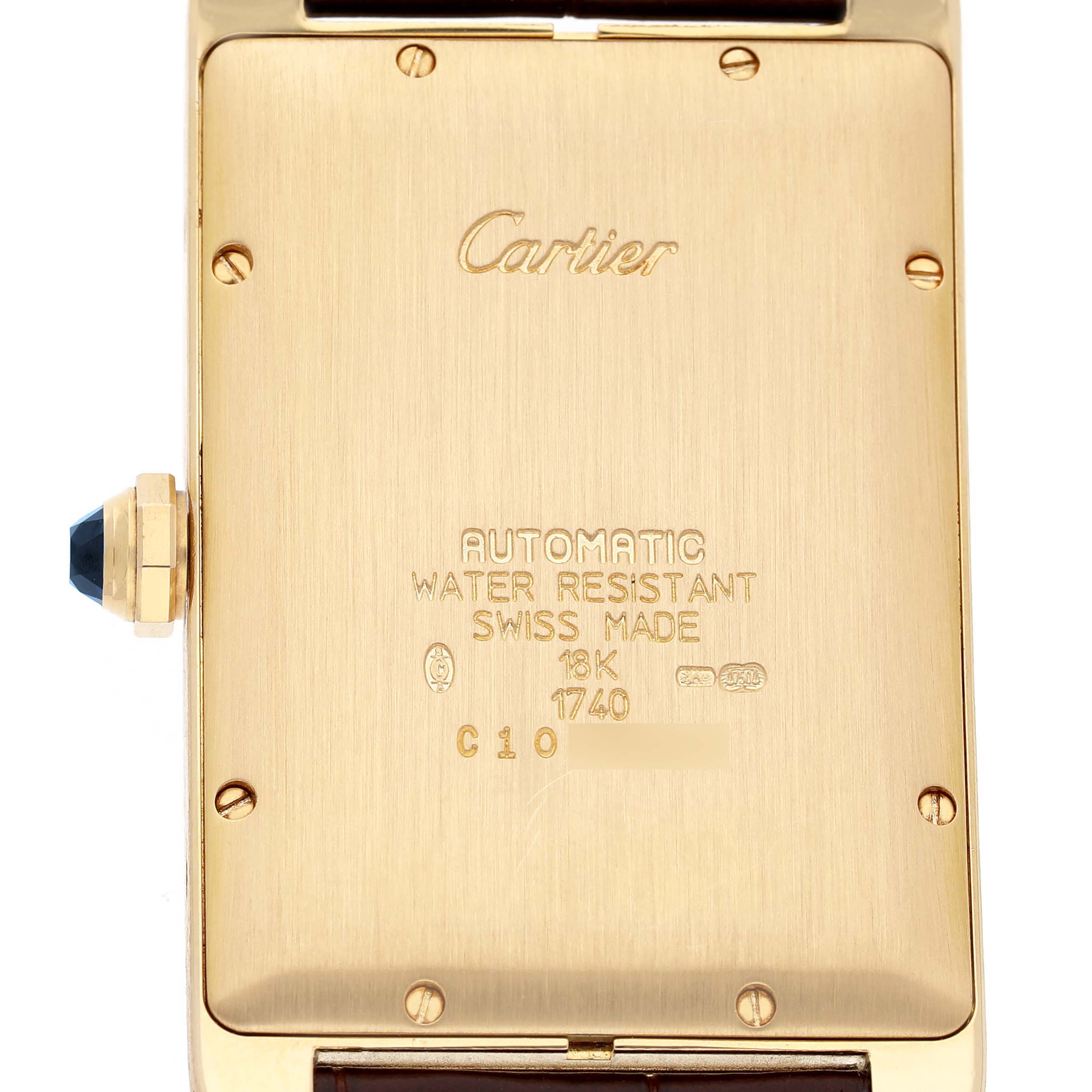 The image shows the back case of the Cartier Tank Americaine W2603156 Men's Yellow Gold Silver Dial watch, highlighting the inscriptions and crown.