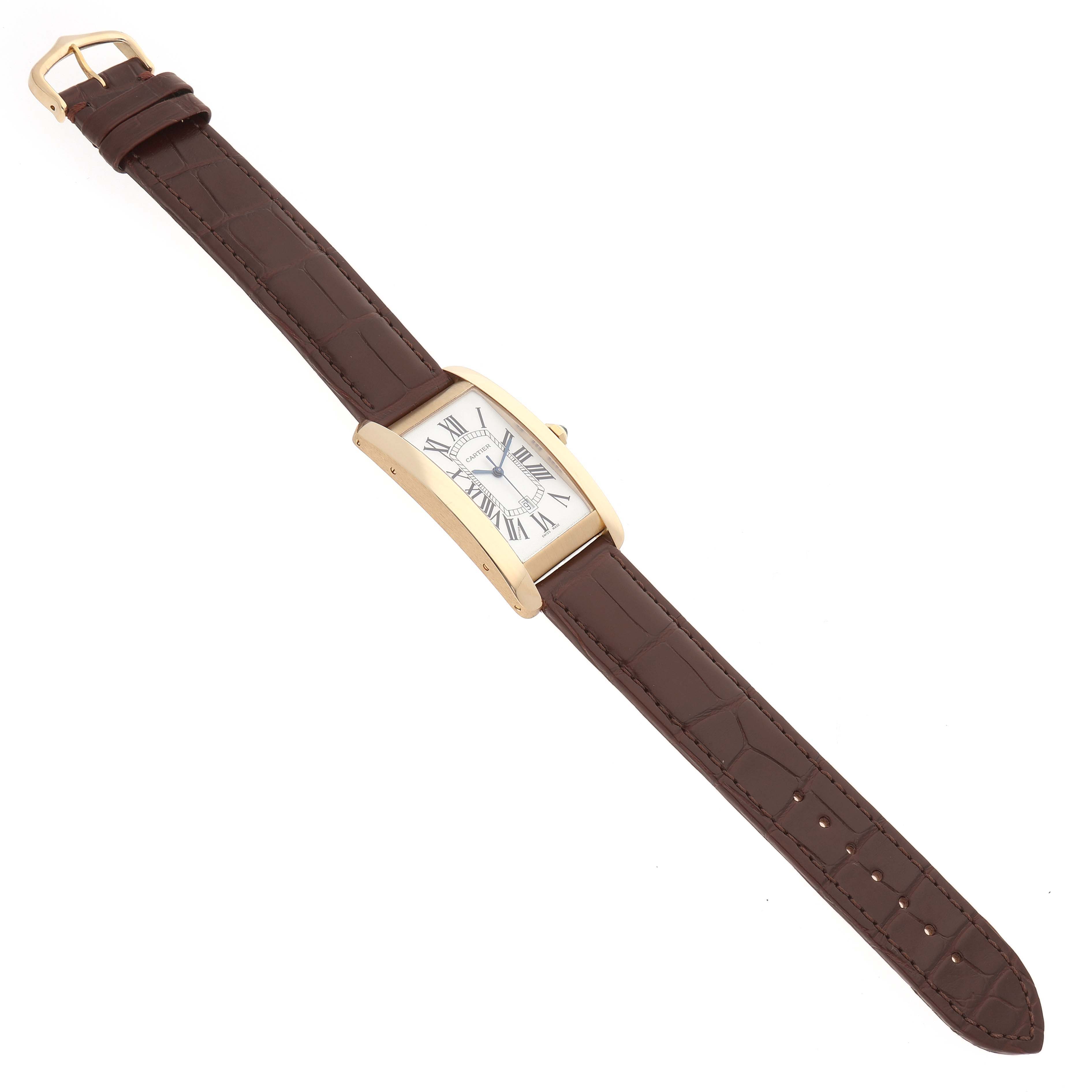 The Cartier Tank Americaine W2603156 Men's Yellow Gold Silver Dial watch is shown at an angle, displaying its brown leather strap and gold case.