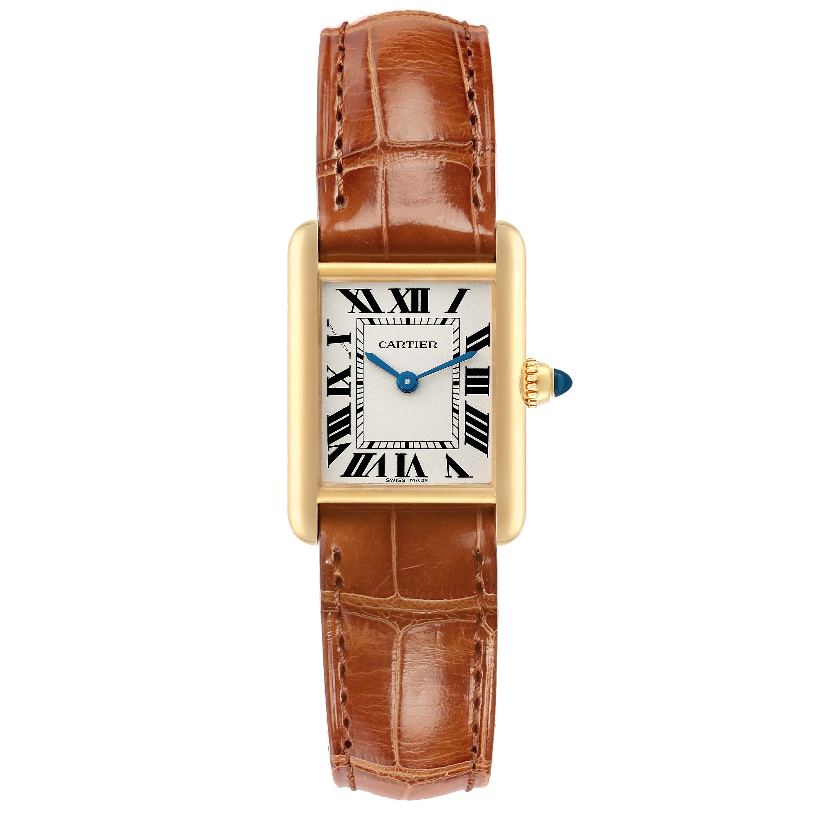 The Cartier Tank Louis W1529856 Women
s Yellow Gold Silver Dial watch is shown from a top-down angle, displaying its rectangular face, gold casing, roman numerals, and brown leather strap.
