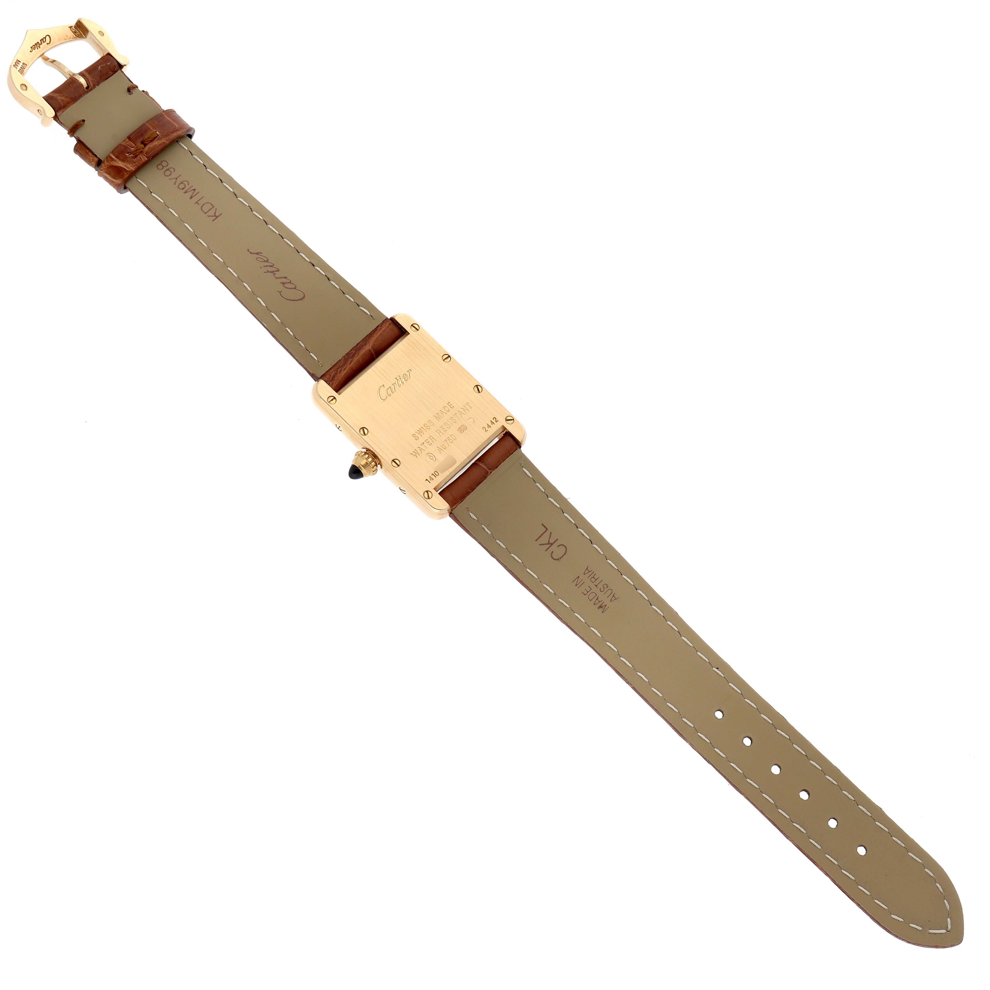 The image shows the back and strap of a Tank Louis Cartier watch, taken from a top-down angle.