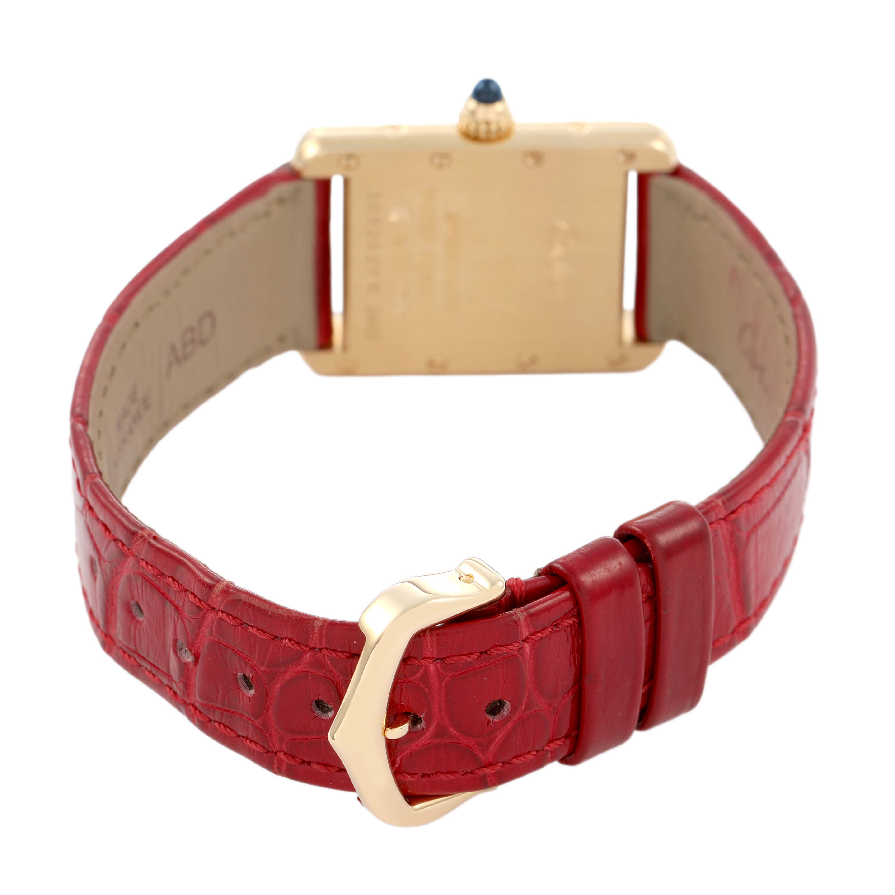 The Cartier Tank Louis W1529856 Women's Yellow Gold Silver Dial watch is shown from the back, displaying the red leather strap and gold buckle.