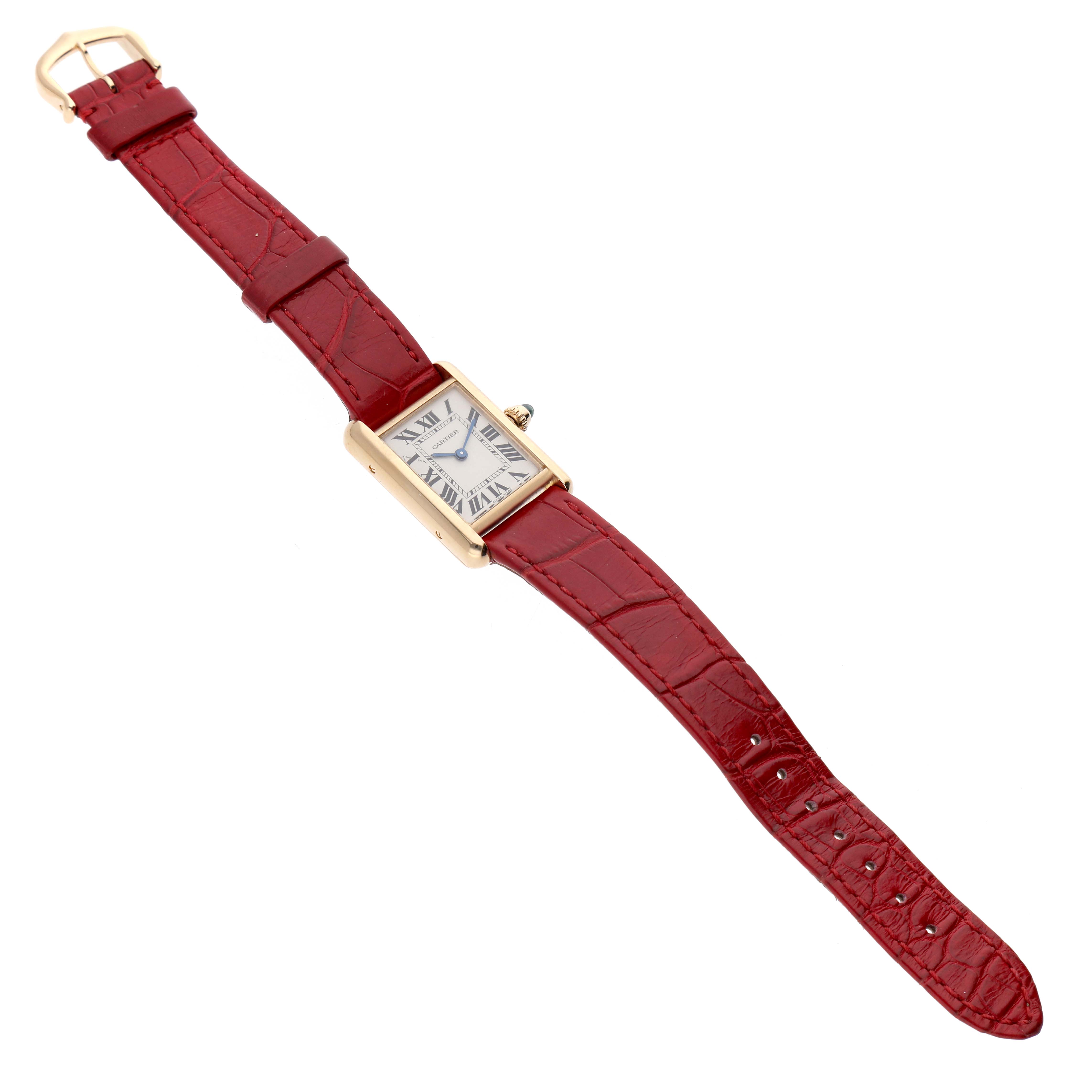 The Cartier Tank Louis W1529856 Women's Yellow Gold Silver Dial watch is shown from above, displaying the front face, red strap, and clasp.