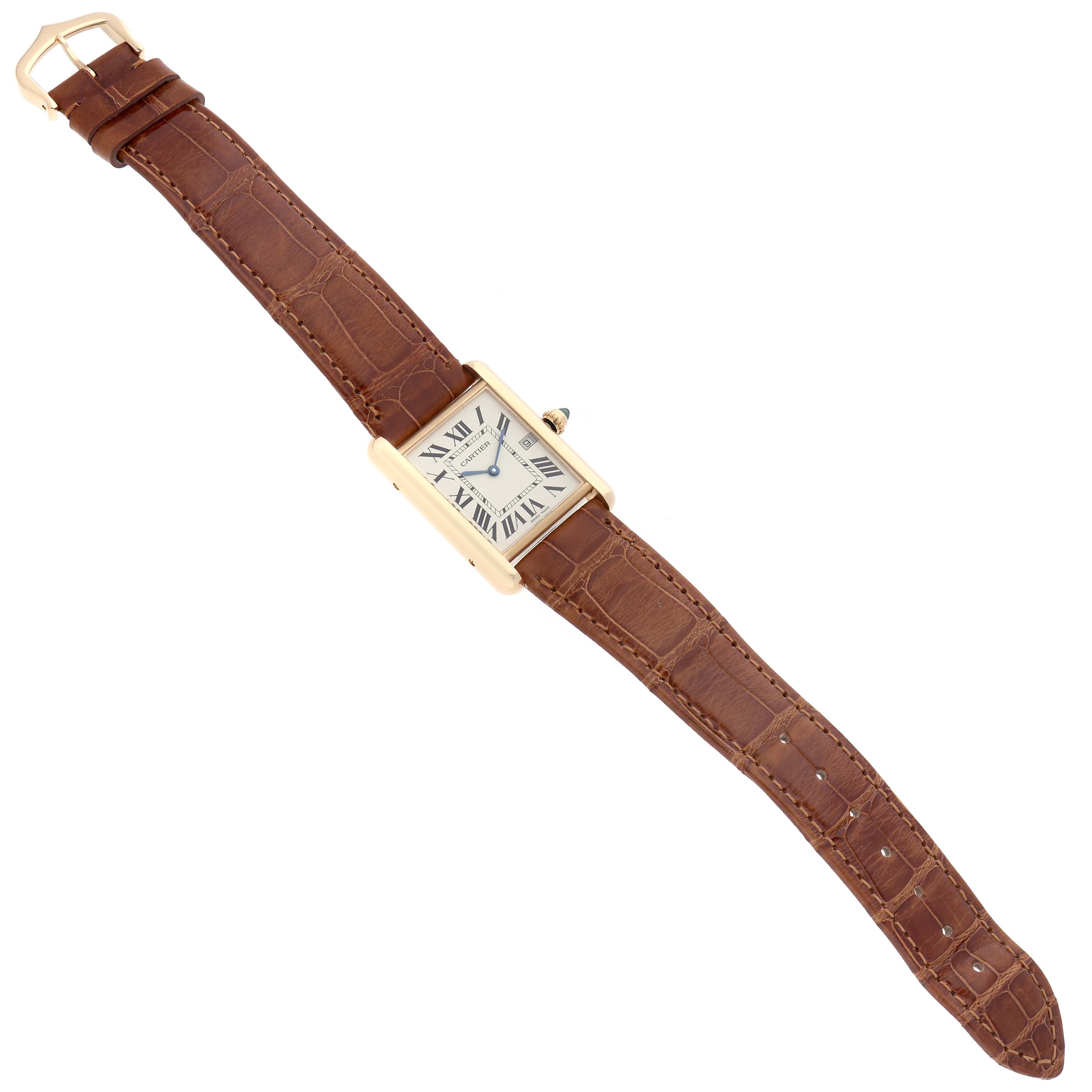 The Cartier Tank Louis W1529756 Men
s Yellow Gold Silver Dial watch is shown from an angled top view, displaying its brown leather strap and rectangular gold case.
