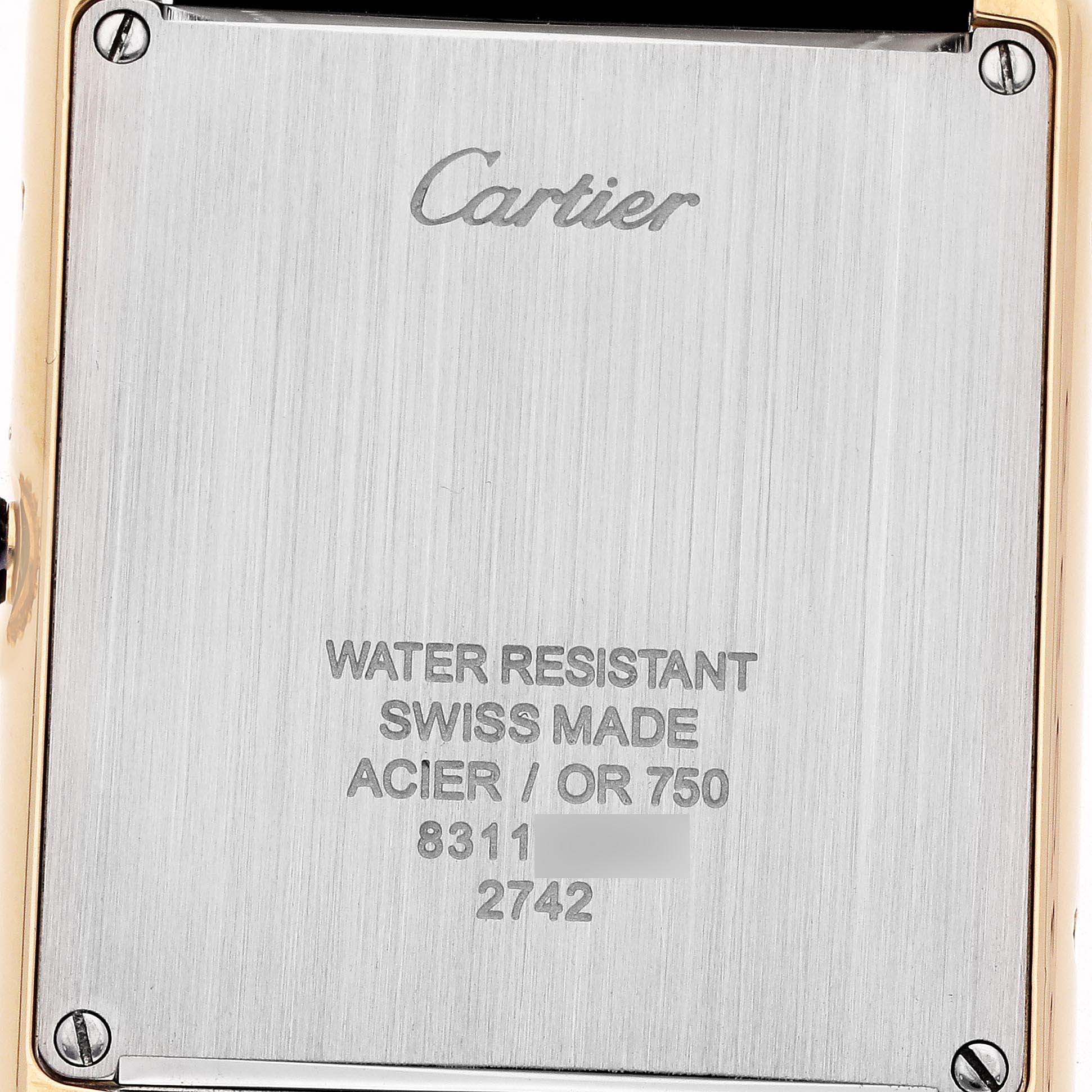 The image shows the back case of a Cartier Tank Solo W1018855 Men
s Steel and Gold (two tone) Silver Dial watch, highlighting engraving and screws.