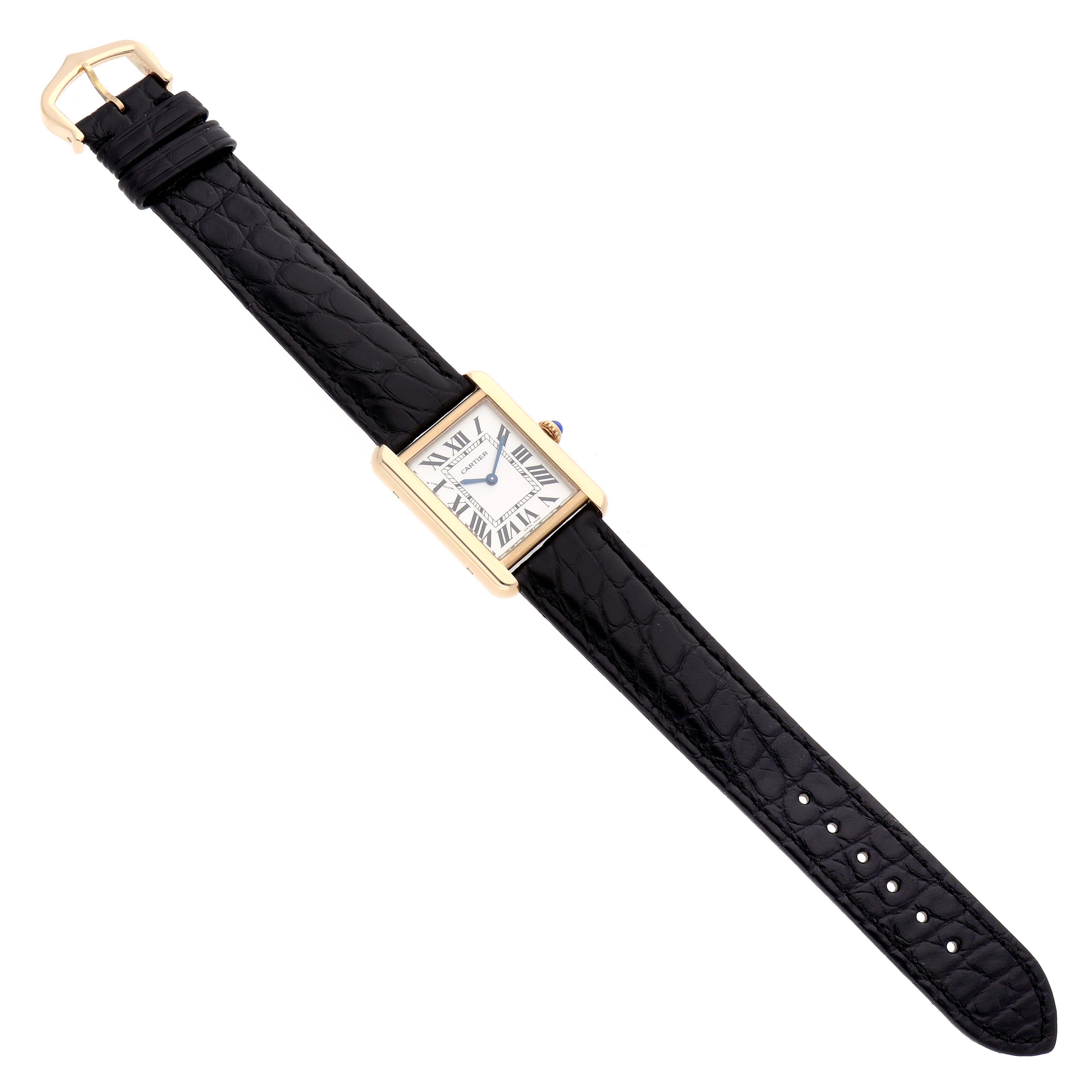 The Cartier Tank Solo W5200002 Women
s Steel and Gold (two tone) Silver Dial watch is shown from a top view, displaying its black strap, gold case, and Roman numeral dial.