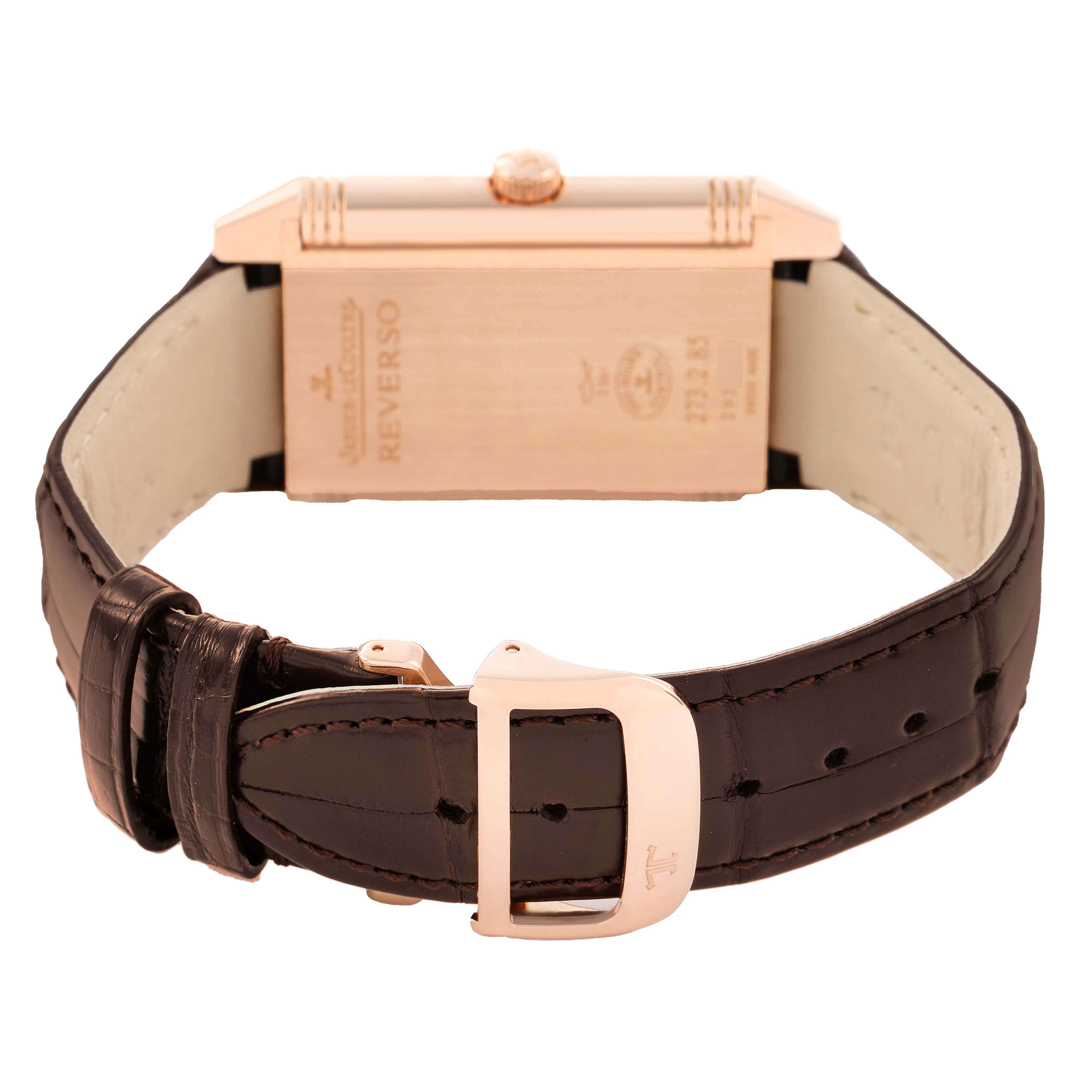 The Jaeger-LeCoultre Reverso watch is shown from the back, highlighting the strap and clasp.