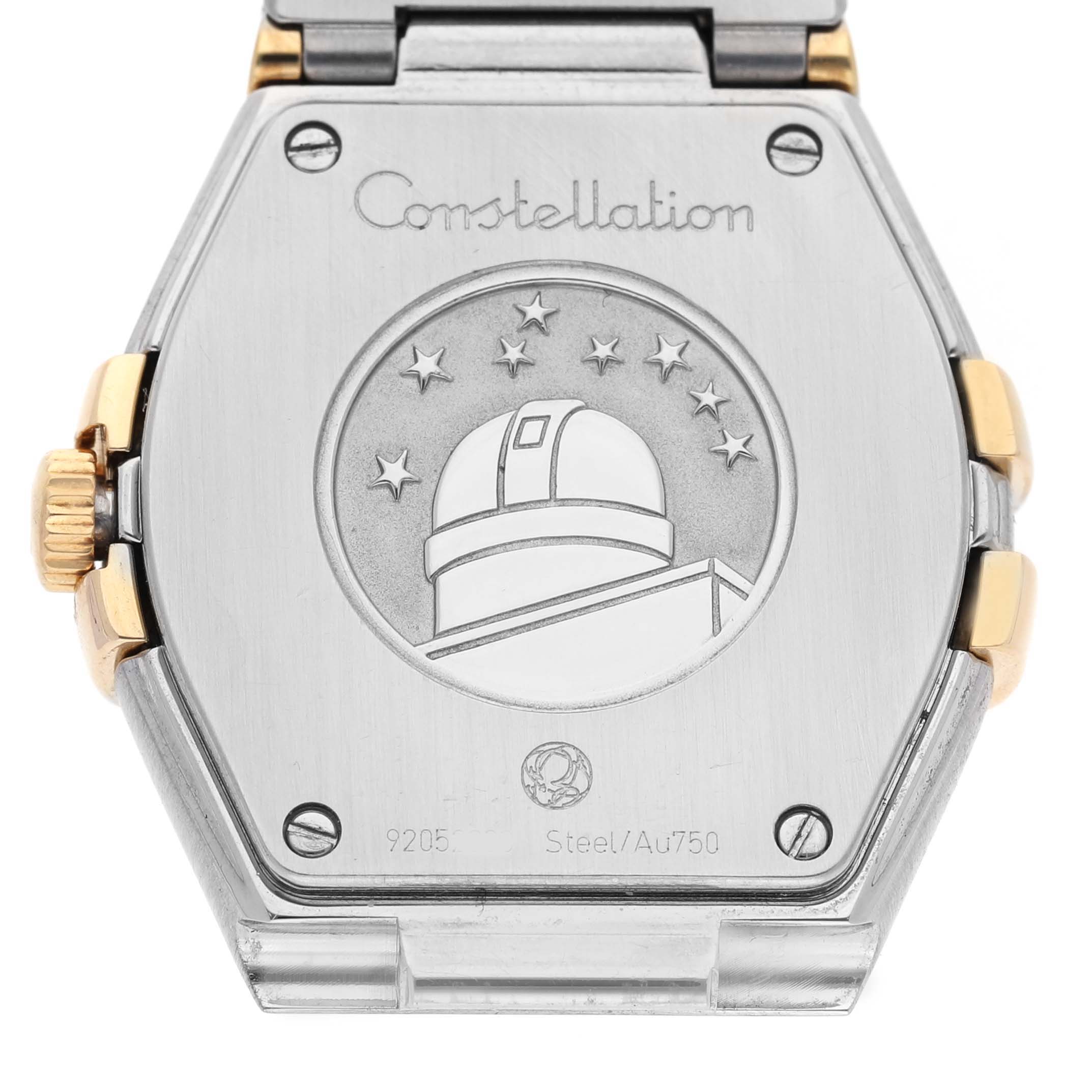 The image shows the back of an Omega 123.25.27.60.52.002 Women's Steel and Gold (two tone) Silver Dial Constellation Steel Yellow Gold Diamond Watch, featuring engravings and the observatory emblem.
