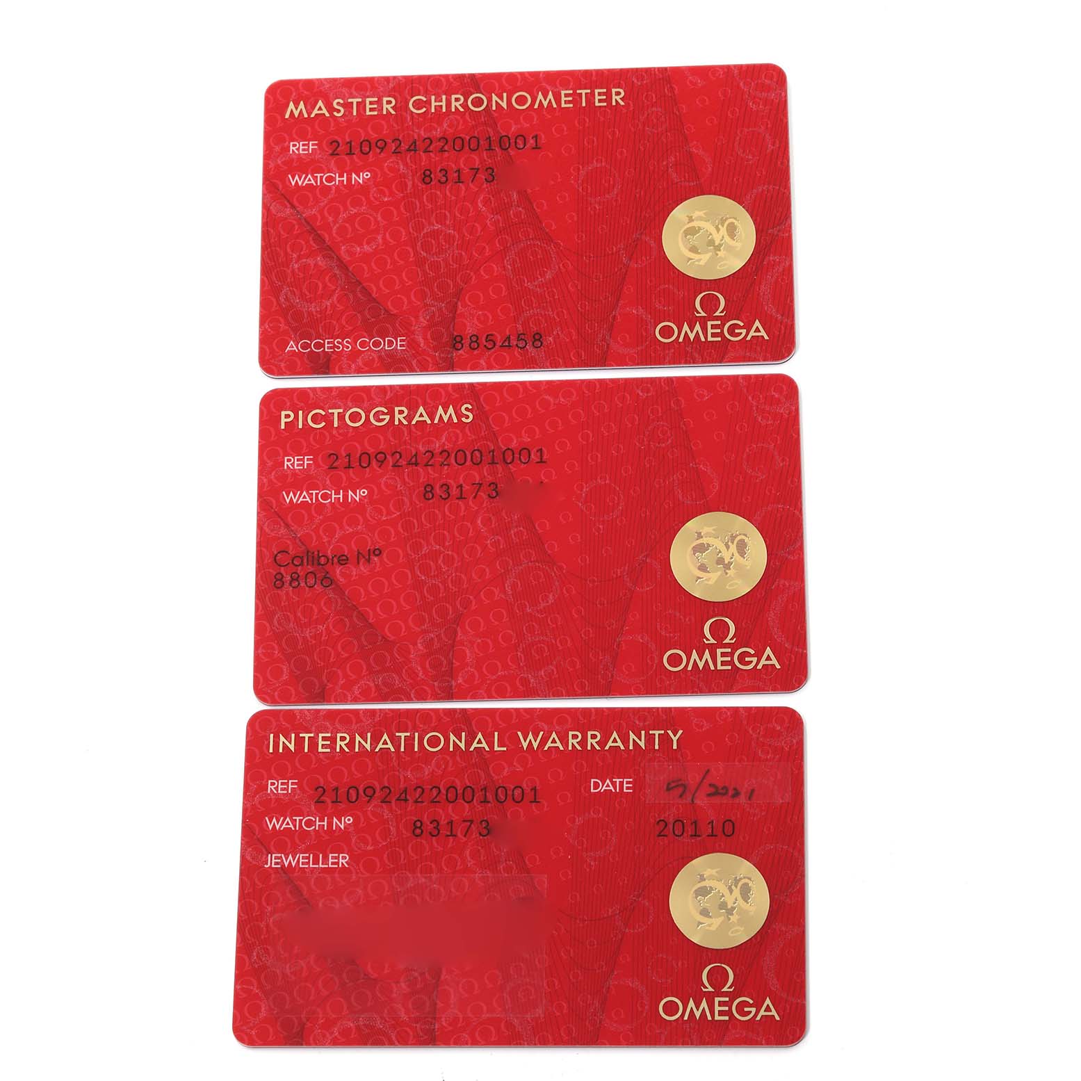 The image shows three red Omega cards for the Seamaster model: Master Chronometer, Pictograms, and International Warranty.