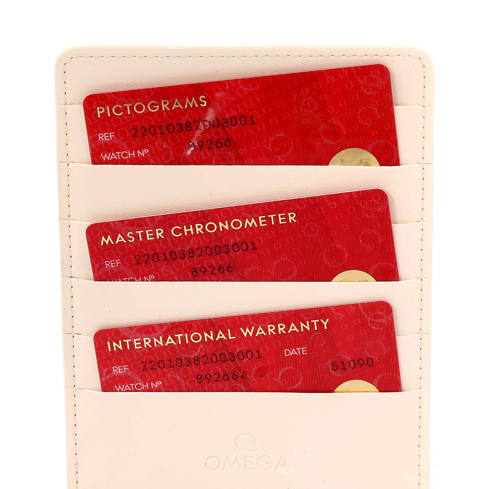 The image shows three red Omega Aqua Terra 220.10.38.20.03.001 Men's Stainless Steel Blue Dial 220.10.38.20.03.001 Men's Stainless Steel Blue Dial cards: Pictograms, Master Chronometer, and International Warranty, in a beige holder.