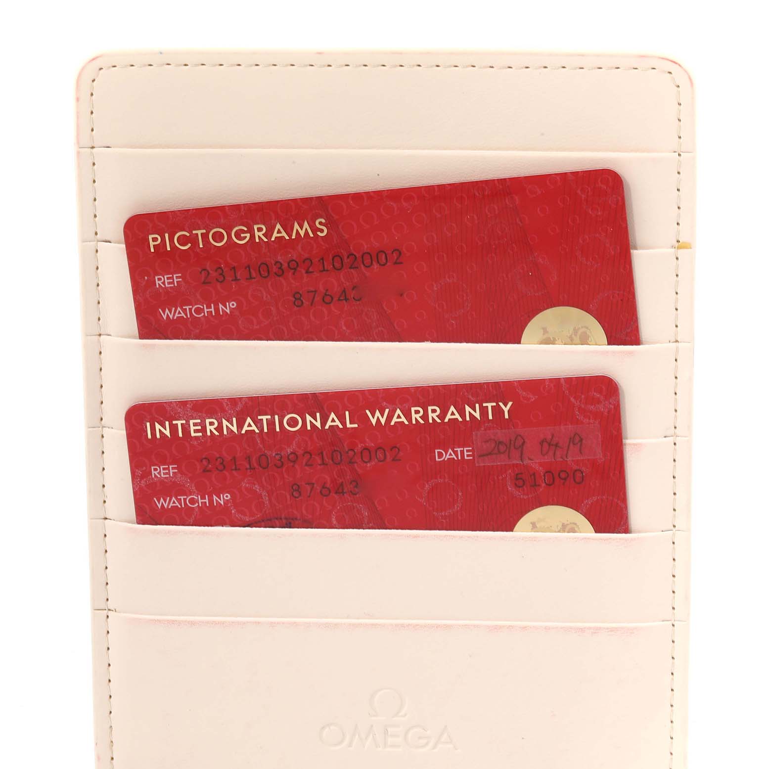 The image shows warranty and pictogram cards in a holder for the Omega Aqua Terra 231.10.39.21.02.002 Men
s Stainless Steel Silver Dial 231.10.39.21.02.002 Men
s Stainless Steel Silver Dial watch.