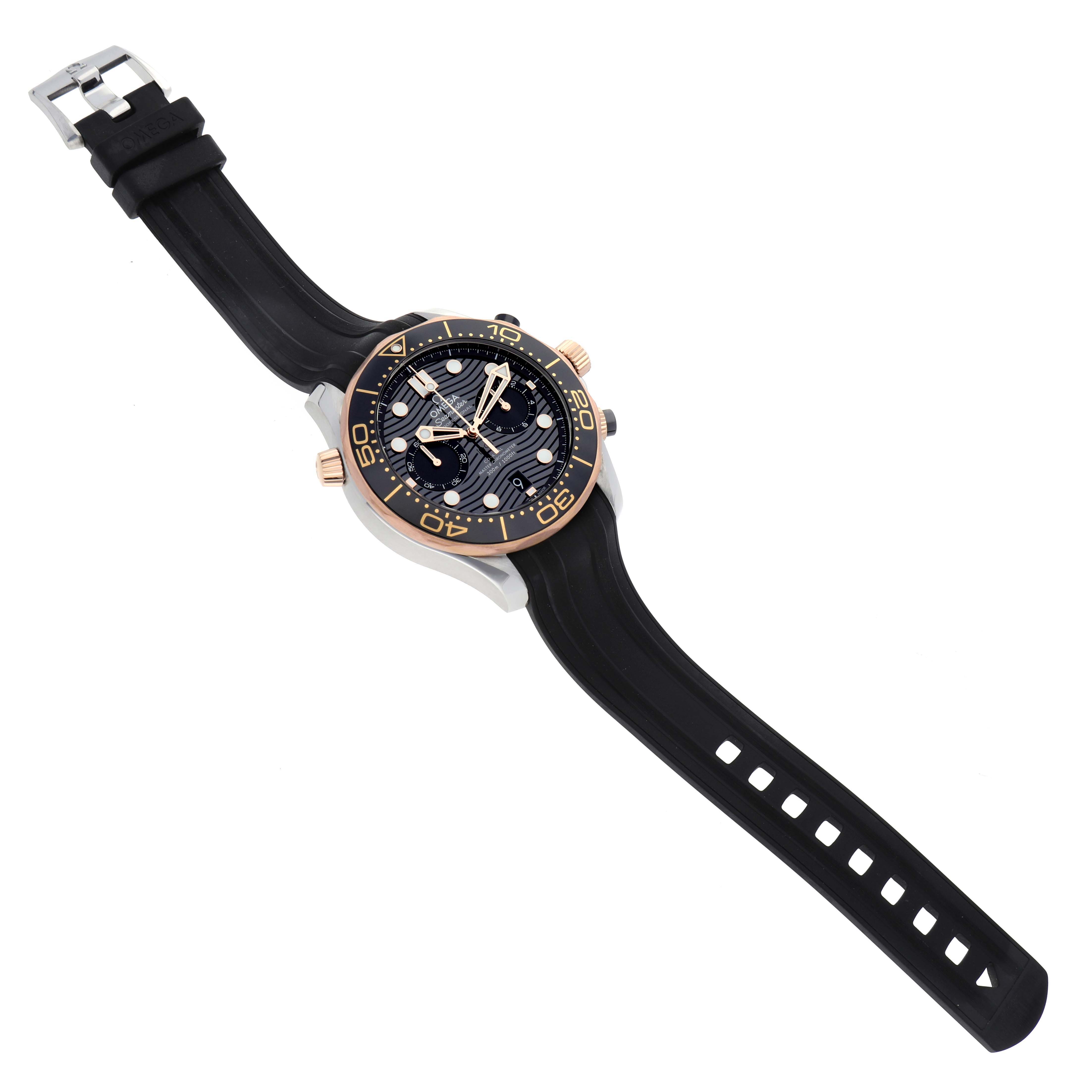 This image shows an Omega Seamaster 210.22.44.51.01.001 Men's Steel and Gold (two tone) Black Dial 210.22.44.51.01.001 Men's Steel and Gold (two tone) Black Dial watch with a black rubber strap, gold-tone bezel, and dial, viewed from a top-down angle.