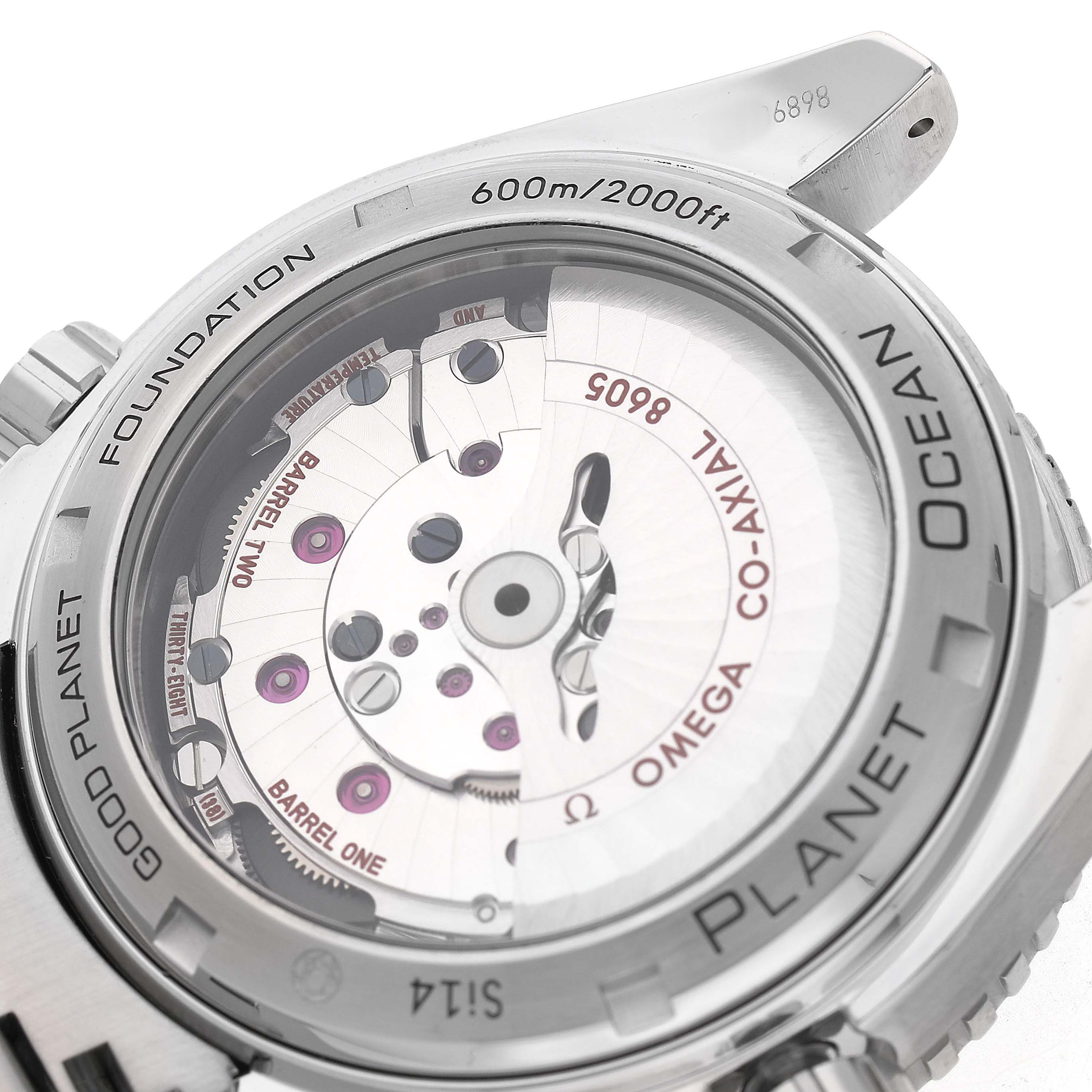 The image shows the back of the Omega Planet Ocean 232.30.44.22.03.001 Men's Stainless Steel Blue Dial watch, highlighting its Co-Axial movement and transparent case back.