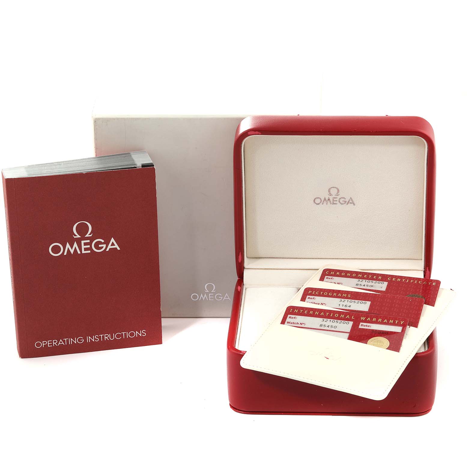 The image shows the packaging, operating instructions, and warranty cards for an Omega Speedmaster 3210.52.00 Men
s Stainless Steel Black Dial 3210.52.00 Men
s Stainless Steel Black Dial watch.