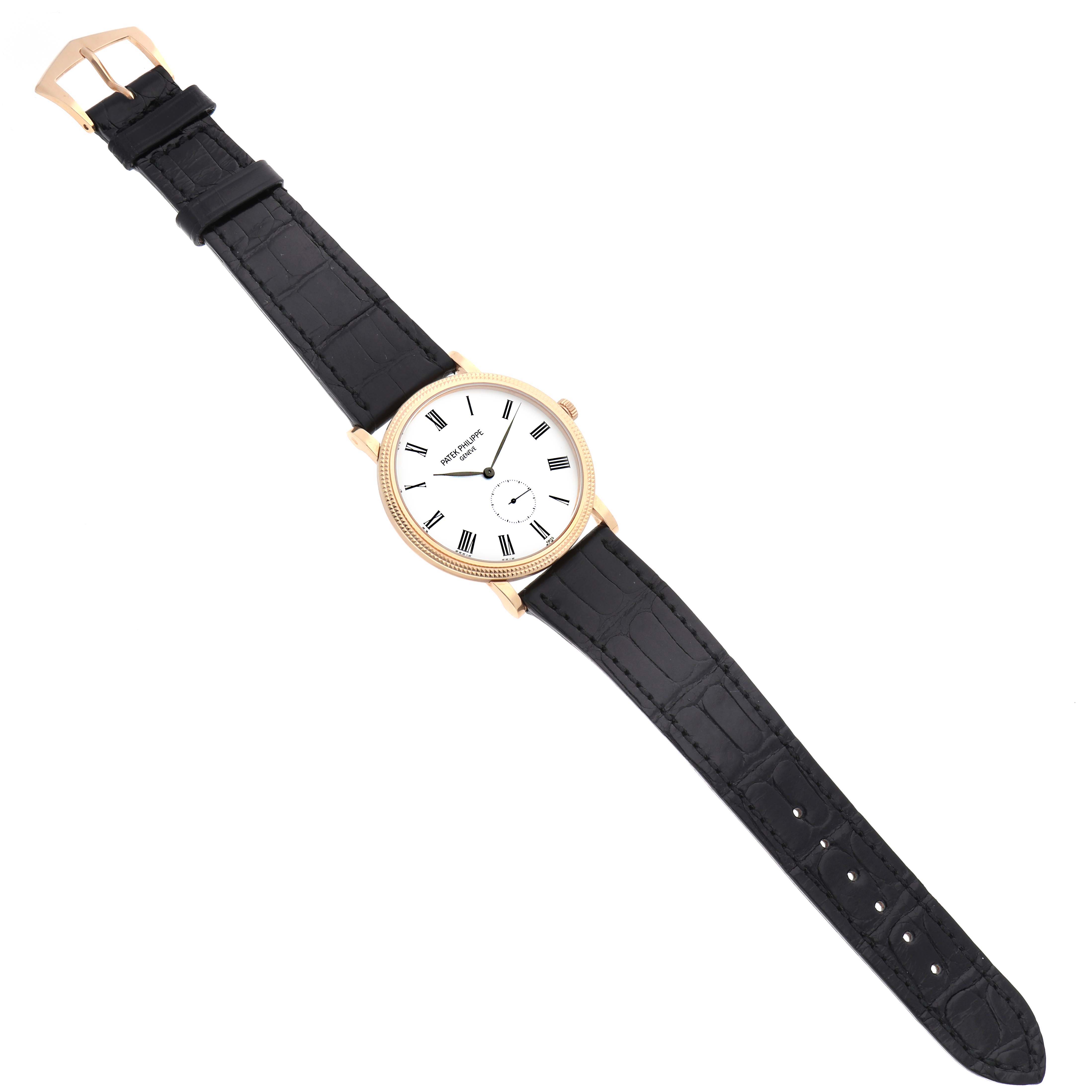 The Patek Philippe Calatrava 5119R Men's Rose Gold White Dial watch is shown from a top-down angle featuring its face, crown, and full leather strap.