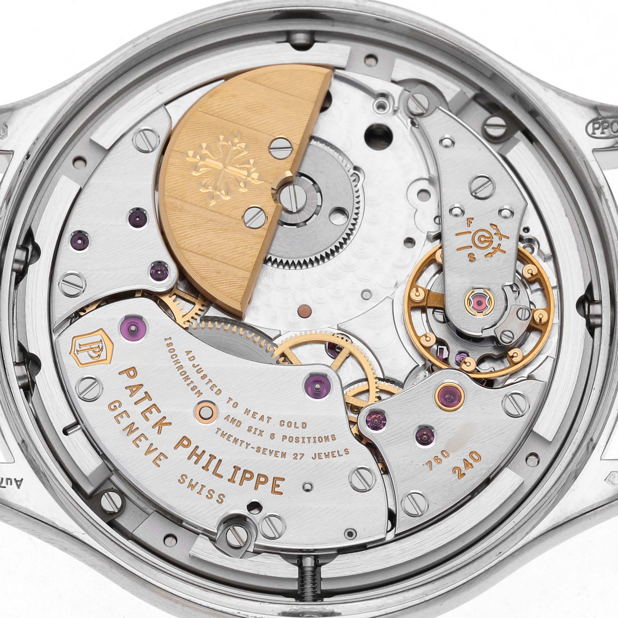 The image shows the movement of a Patek Philippe Complications 7140G-001 Women's White Gold Silver Dial watch from the back, revealing gears and the engraved rotor.