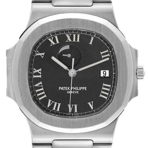 The image shows a front view of the Patek Philippe Nautilus watch, highlighting its black dial, Roman numeral indices, and date display at 3 o'clock.