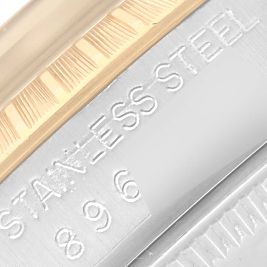 This close-up image shows the stainless steel and gold fluted bezel engraving of a Rolex Date 15053 Men's Steel and Gold (two tone) Champagne Dial 15053 Men's Steel and Gold (two tone) Champagne Dial model watch.