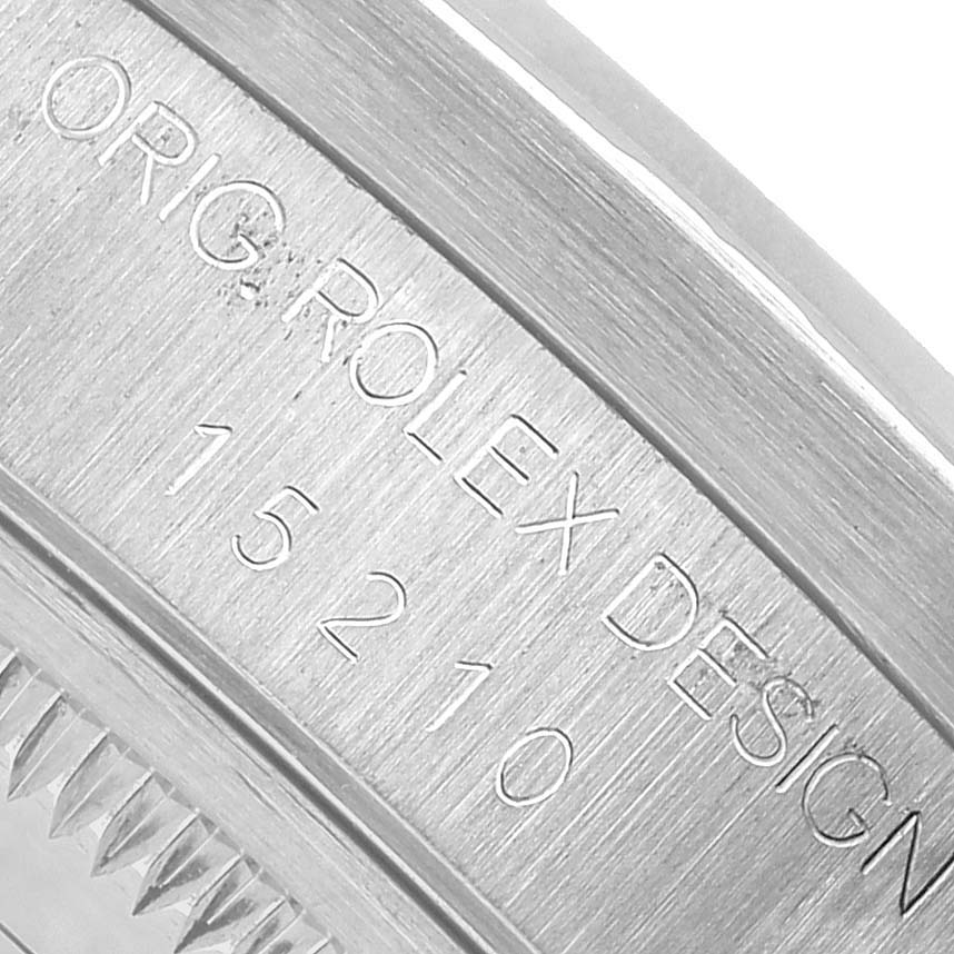 The image shows a close-up of the Rolex Date 15210 Men's Stainless Steel Silver Dial model's engraved inner bezel with "Rolex Design" and a model number.