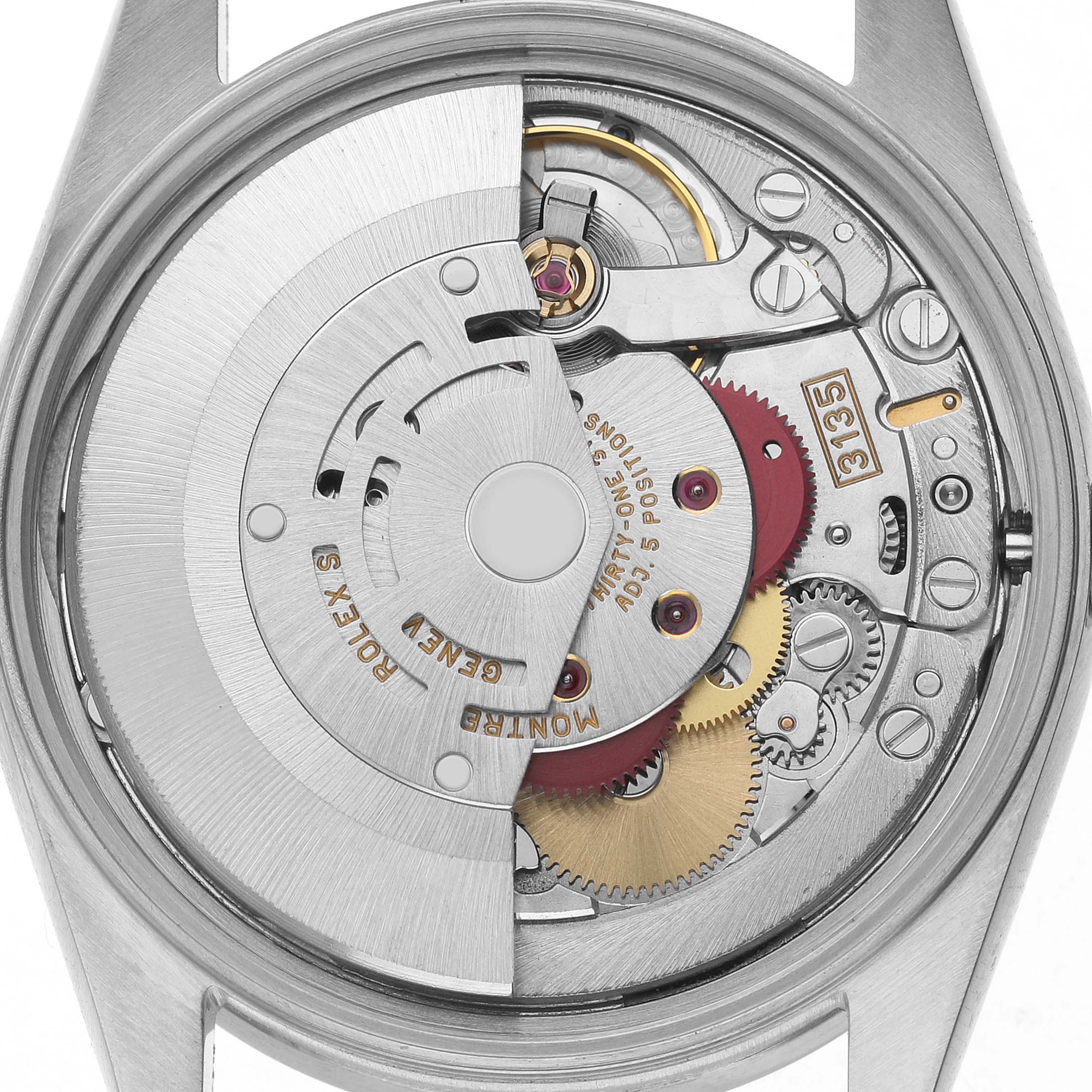 The image shows the internal mechanism of a Rolex Date 15210 Men's Stainless Steel Silver Dial watch, displaying gears and the rotor from a back view.