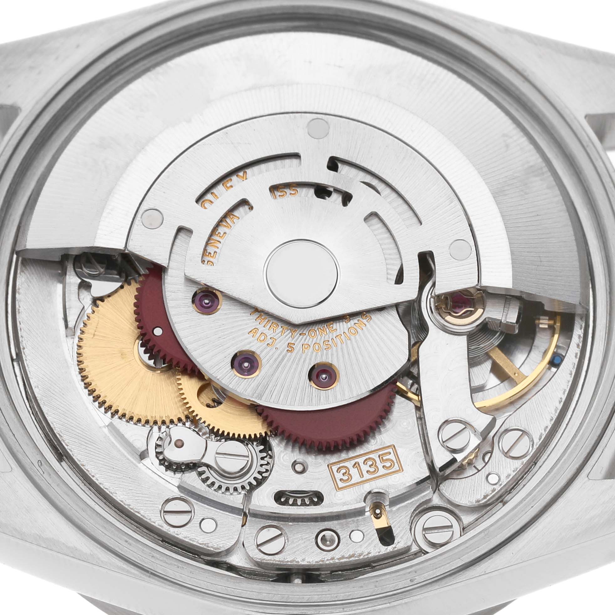 The image shows the internal mechanism of a Rolex Date 15210 Men's Stainless Steel White Dial model watch viewed from the back, highlighting gears and the rotor.