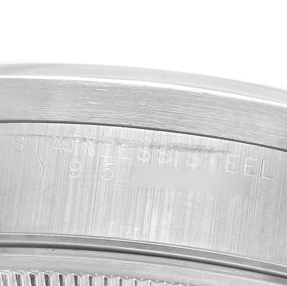 The image shows a close-up of the engraved side of the Rolex Date 15210 Men's Stainless Steel White Dial's stainless steel case.
